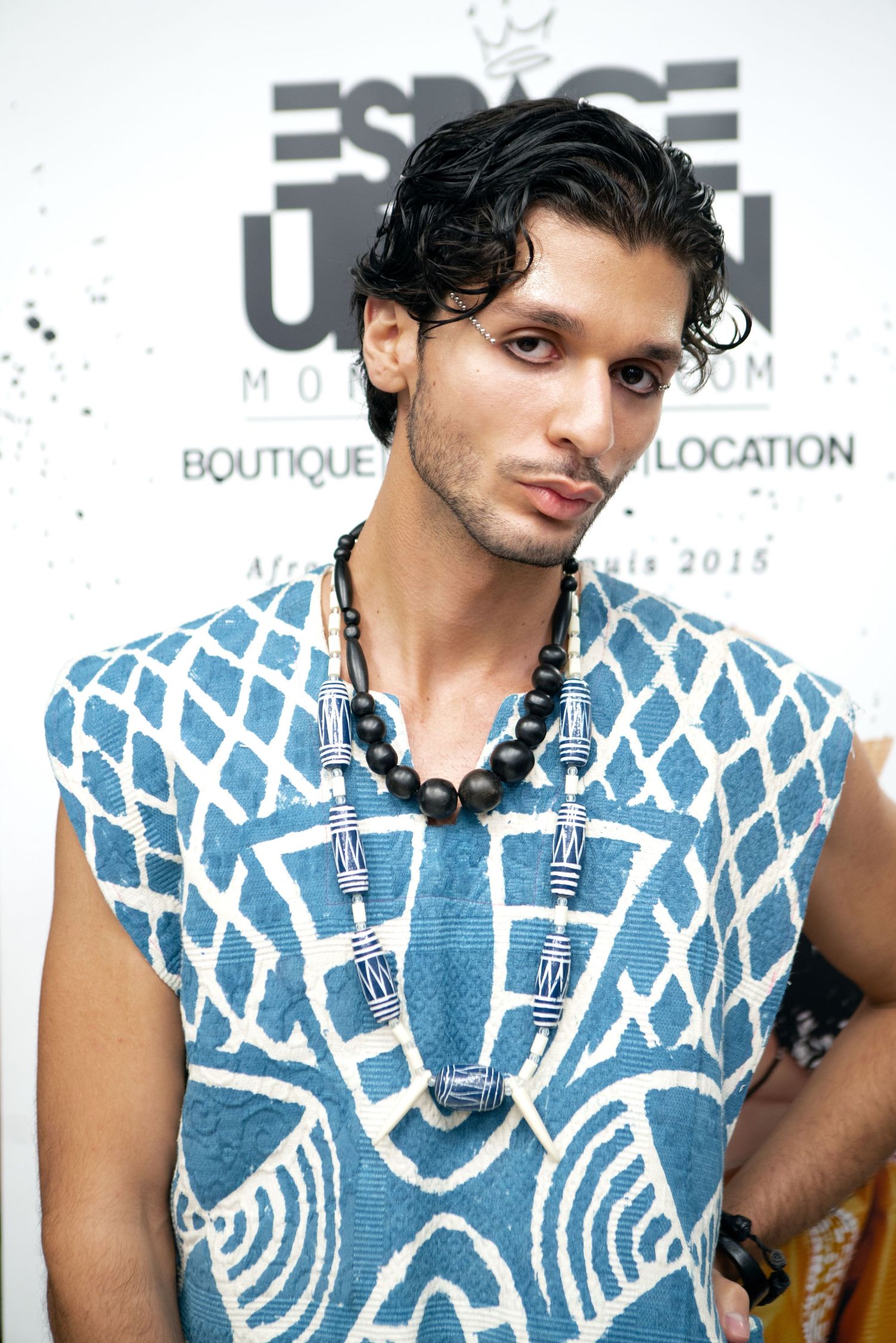 Close-up portrait of a model in a blue patterned shirt, editorial fashion photography by HAMIDI Photography.