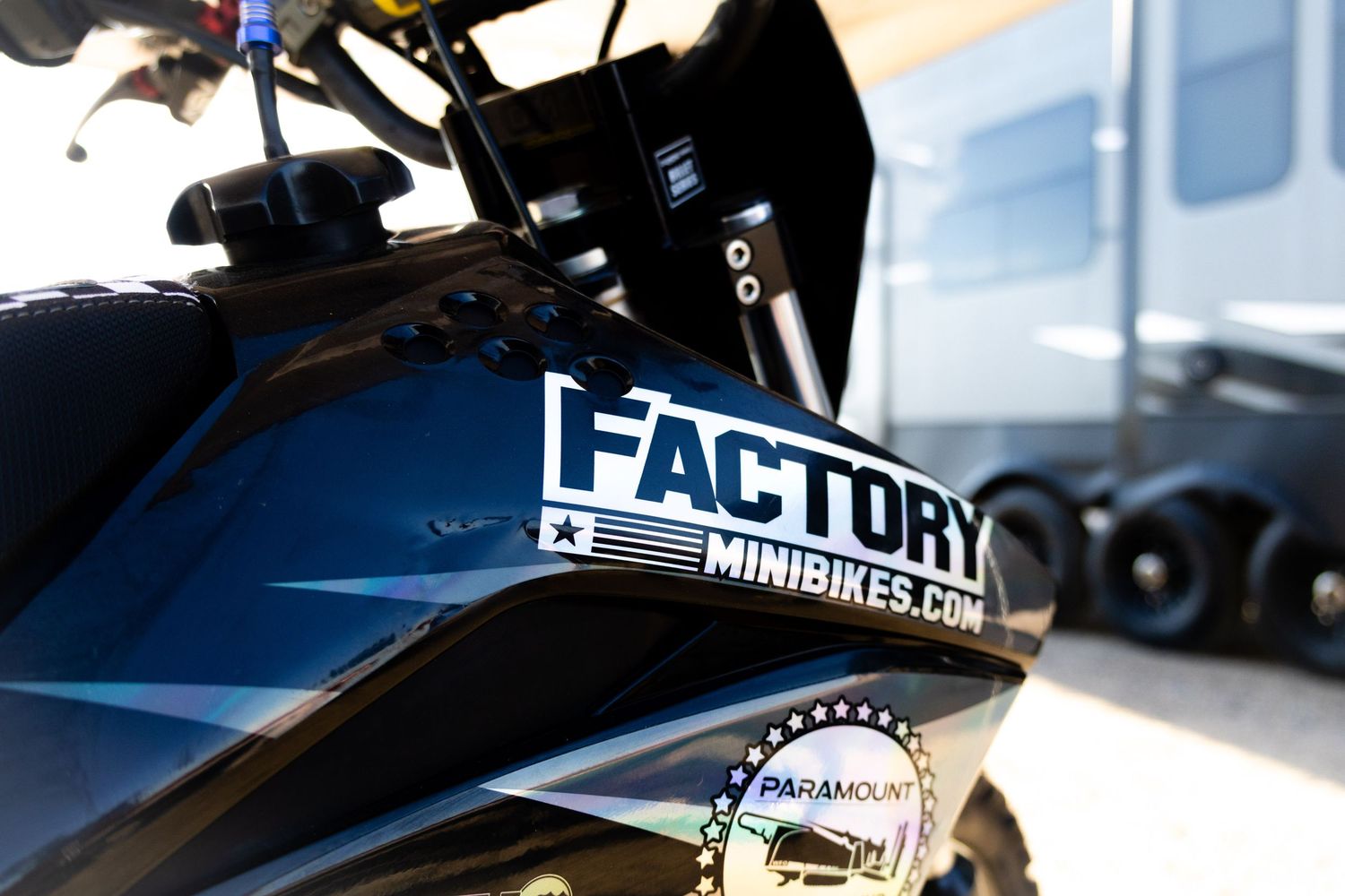 Close-up of a black mini bike with Factory Minibikes.com sticker on the body panel.