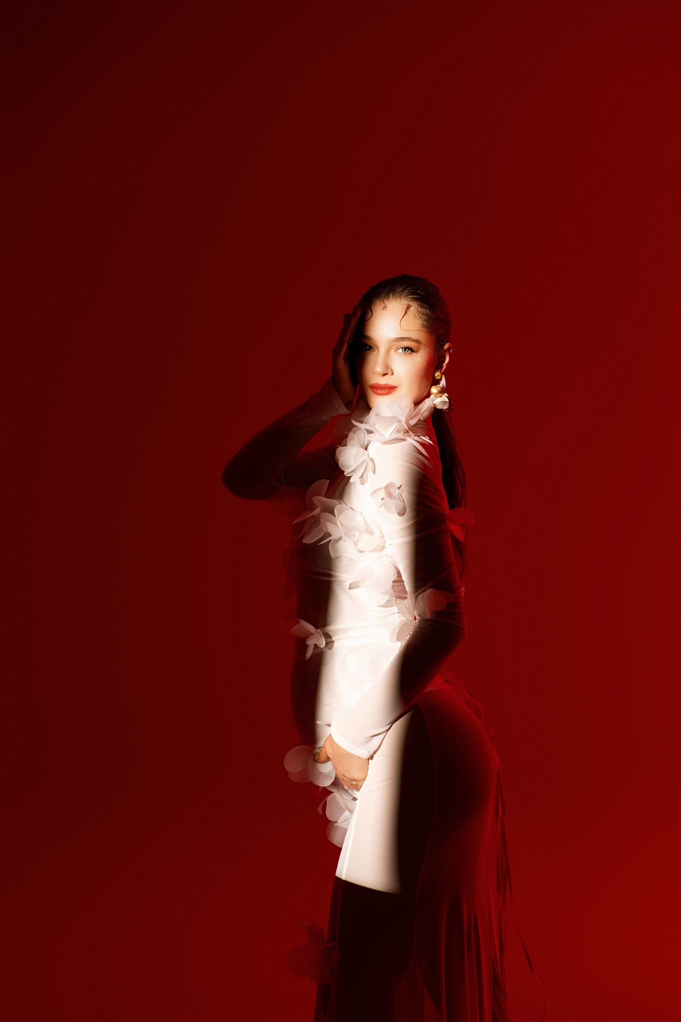 Women in Gold and Colour art project red background and snoot flash light