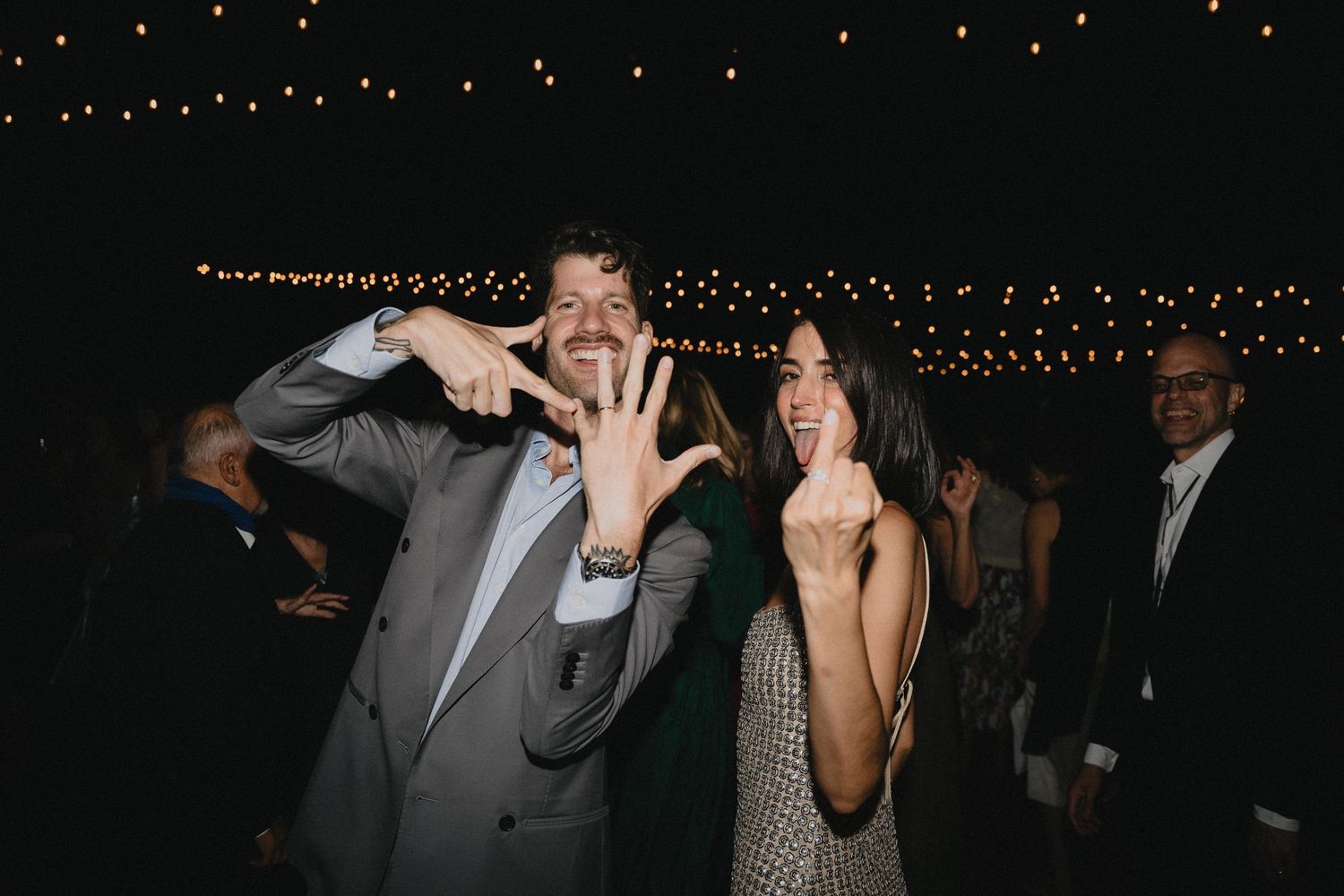 A candid photograph of a couple on the dance floor during wedding.
