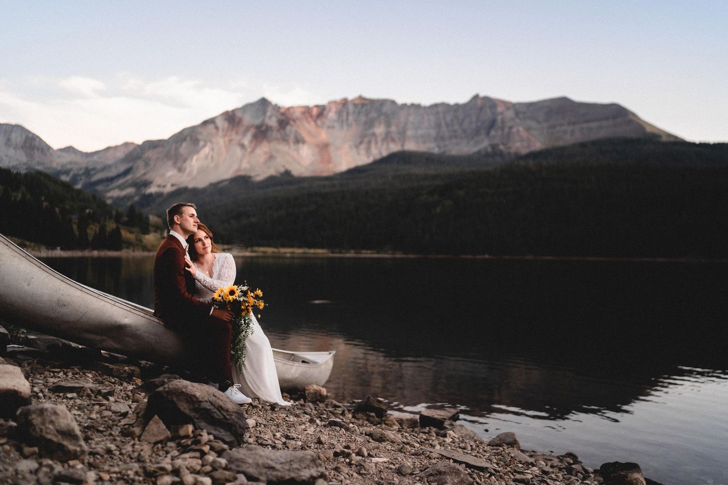 A bride and groom enjoying the sunset during their adventurous wedding photos.