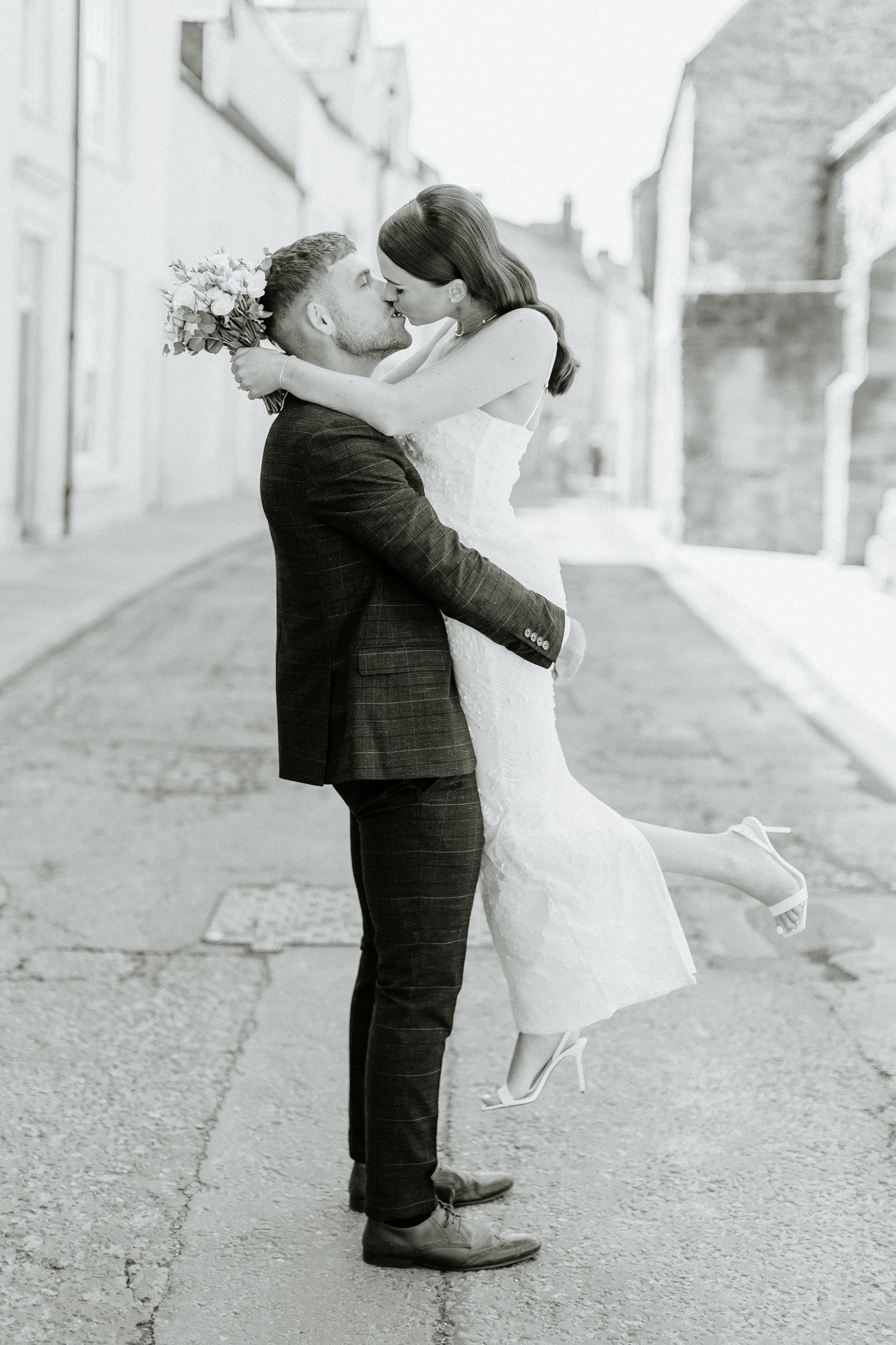 Joyful black and white photo on a historic street.