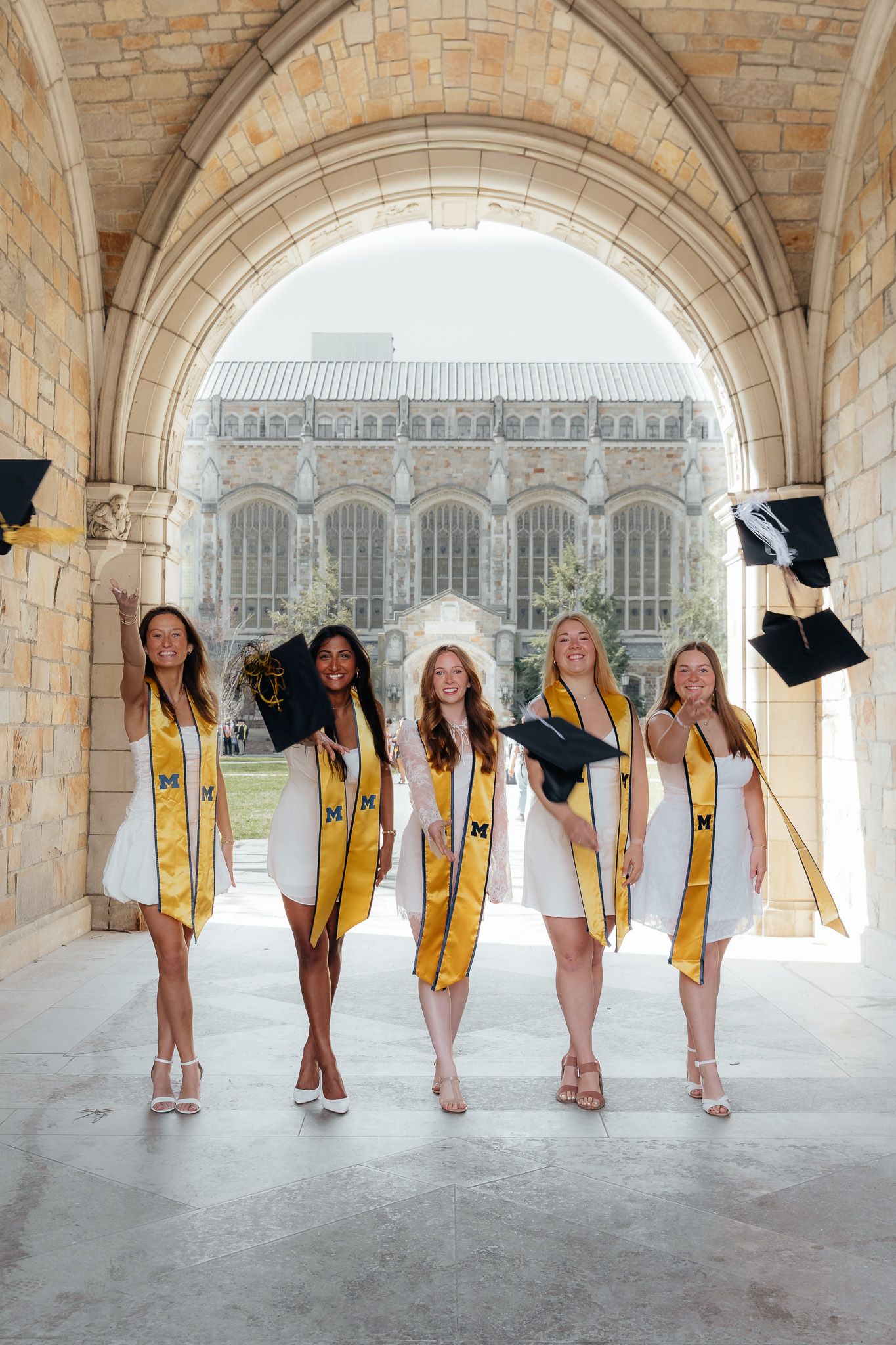 U of M Friends celebrating graduation at campus in Ann Arbor photographed by Brena B Imagery. Graduation inspo.
