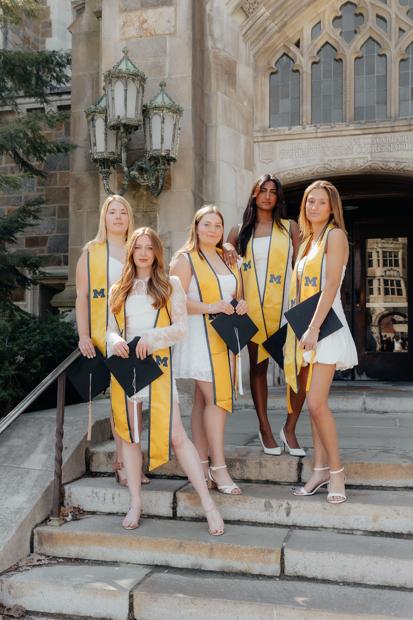 U of M Friends celebrating graduation at campus in Ann Arbor photographed by Brena B Imagery. Graduation inspo.
