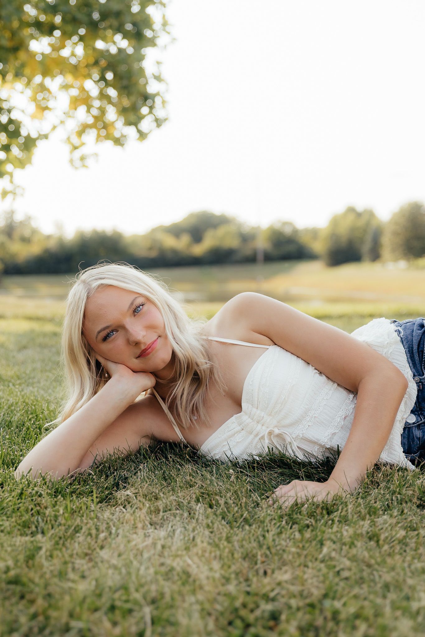 Senior girl smiling during golden hour senior photos in Howell, MI. Brena B Imagery