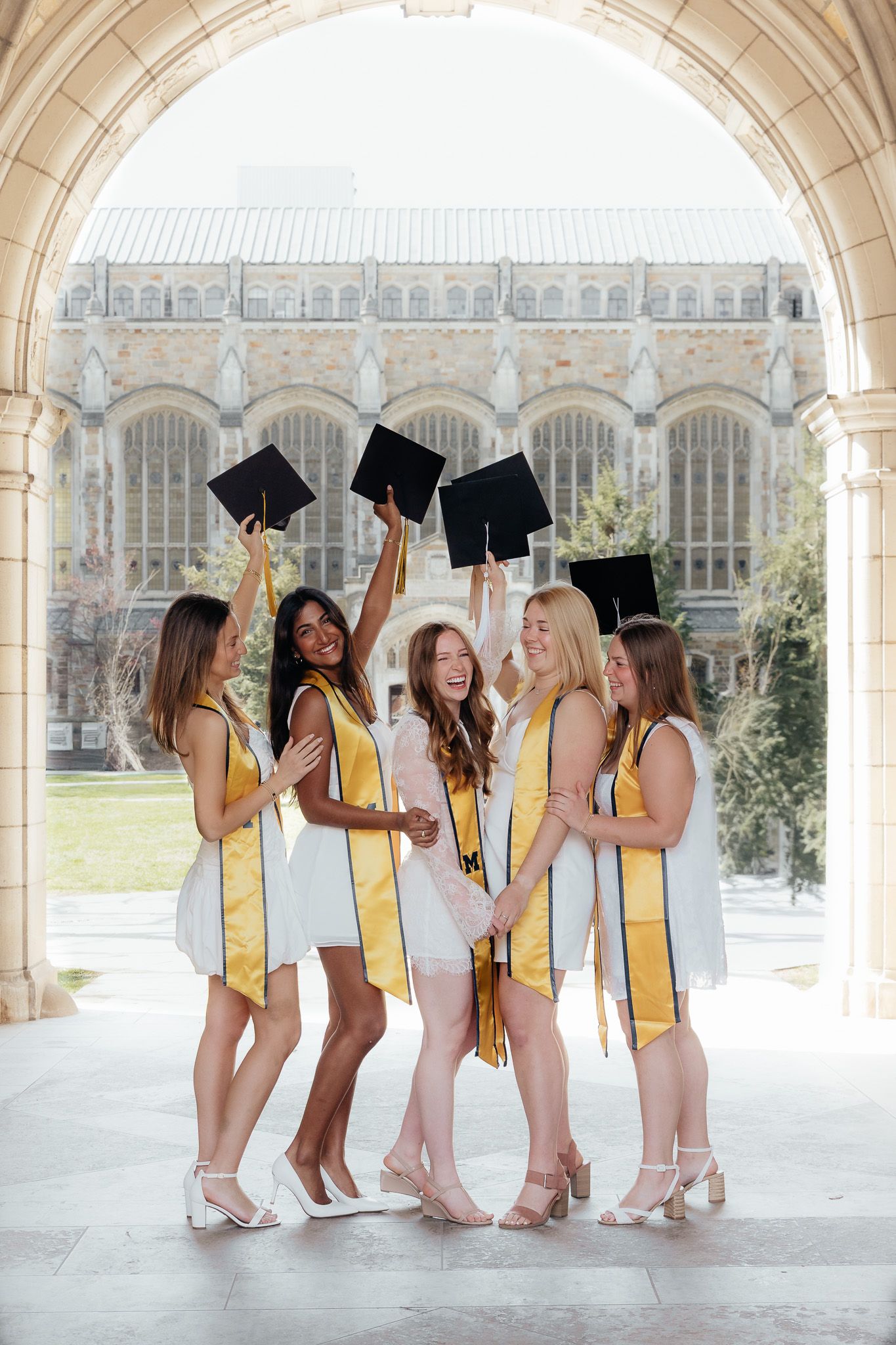 U of M Friends celebrating graduation at campus in Ann Arbor photographed by Brena B Imagery. Graduation inspo.