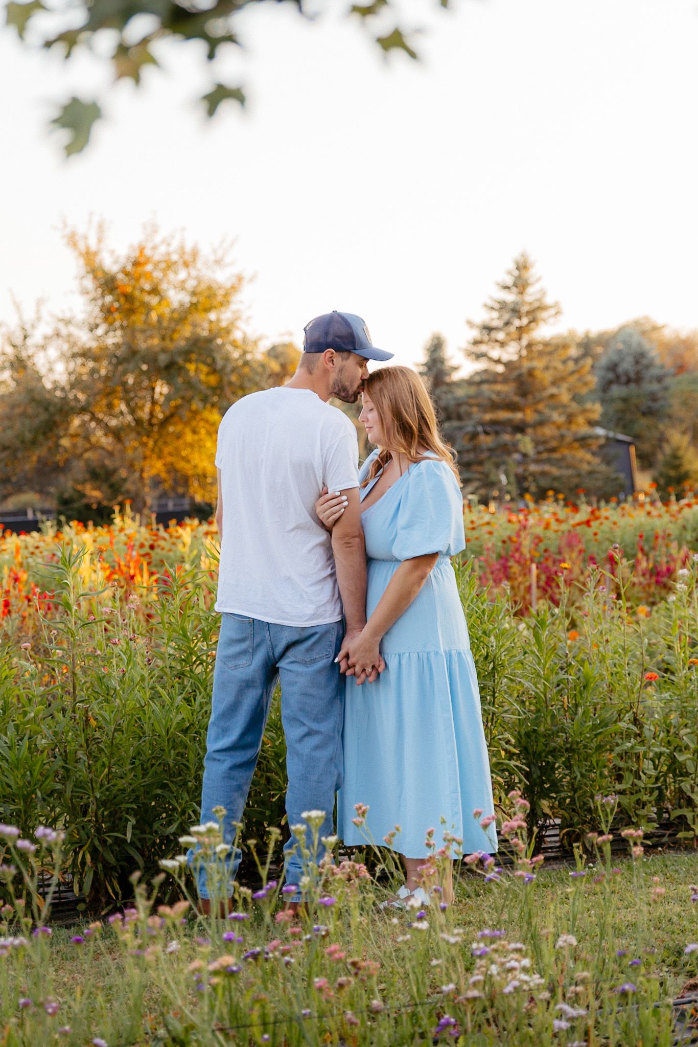 Romantic golden hour engagement session in a flower field in East Lansing, MI. Brena B Imagery