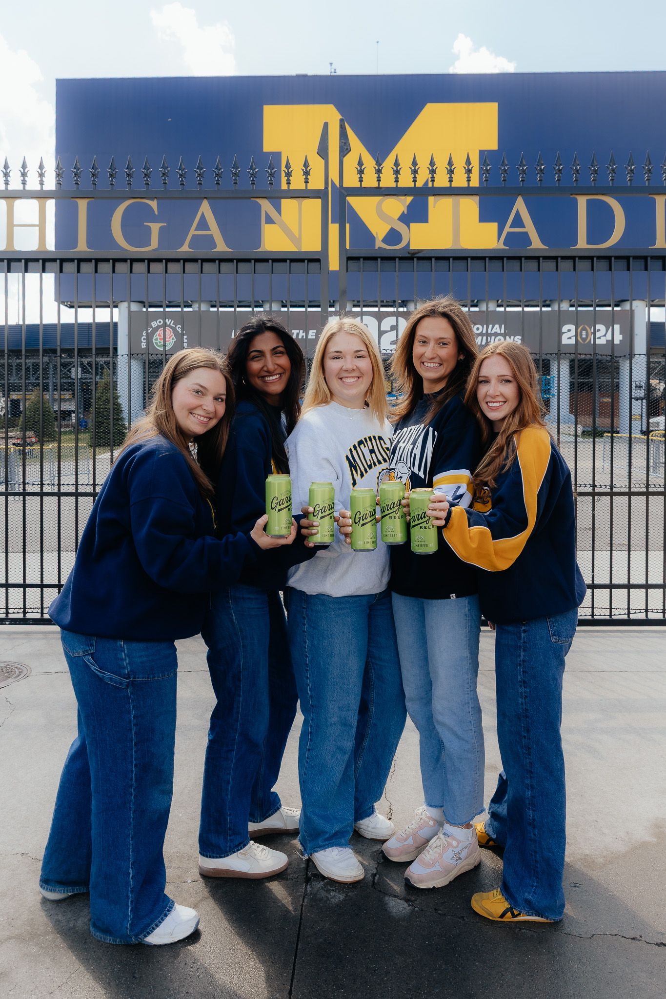 U of M Friends celebrating graduation at the Michigan Stadium in Ann Arbor photographed by Brena B Imagery. Graduation inspo.