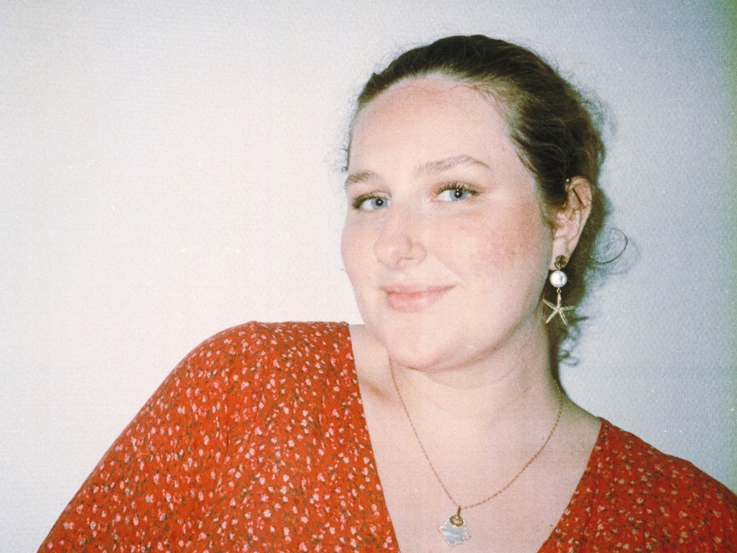 A series of candid flash photos showing someone in an orange polka dot top posing with different expressions.