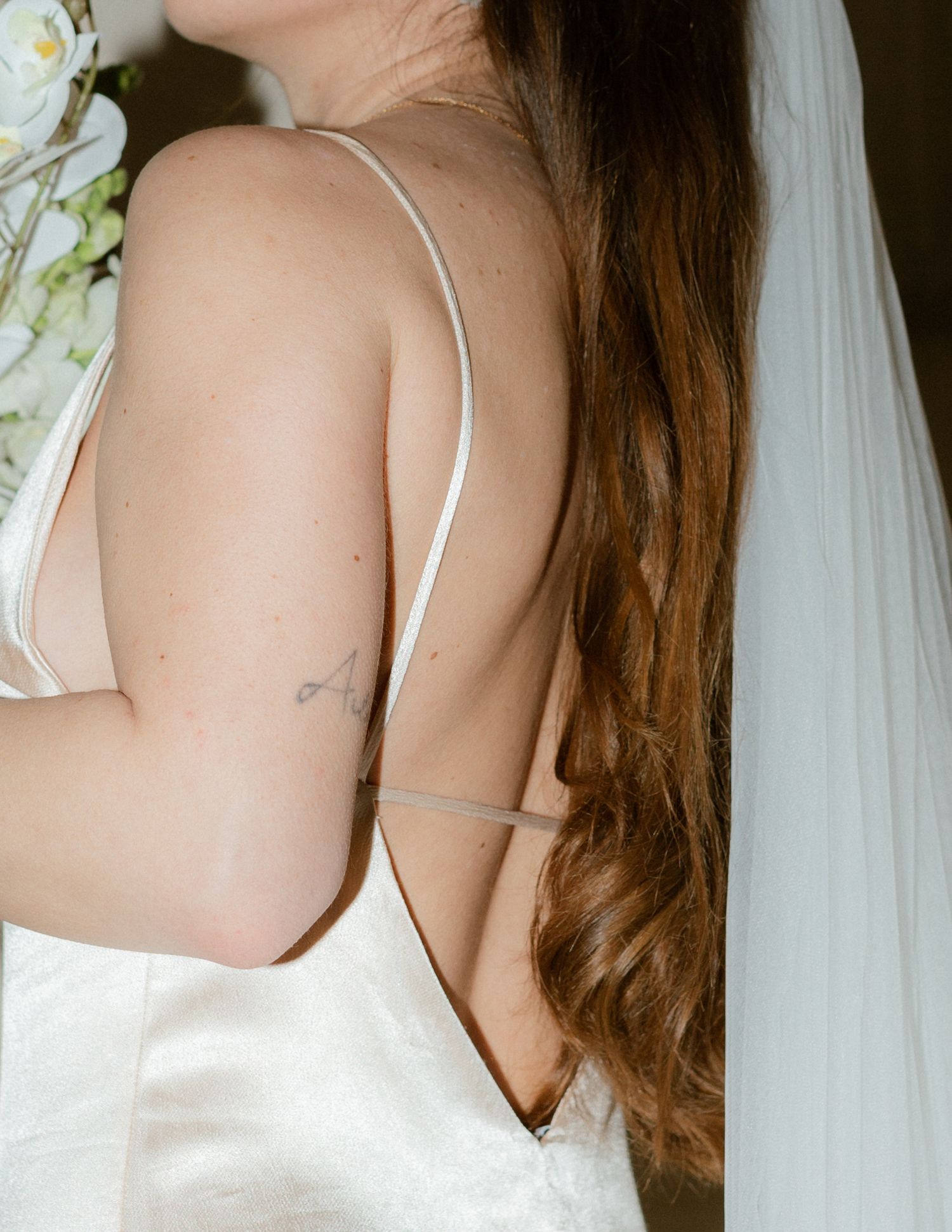 A bride in a white satin dress with thin straps is shown from different angles against a light background.