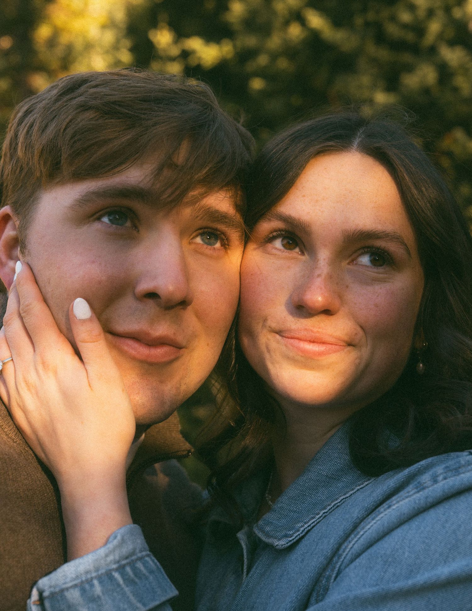 Five connected photos show a couple in denim sharing intimate candid moments against a warm sunlit background.