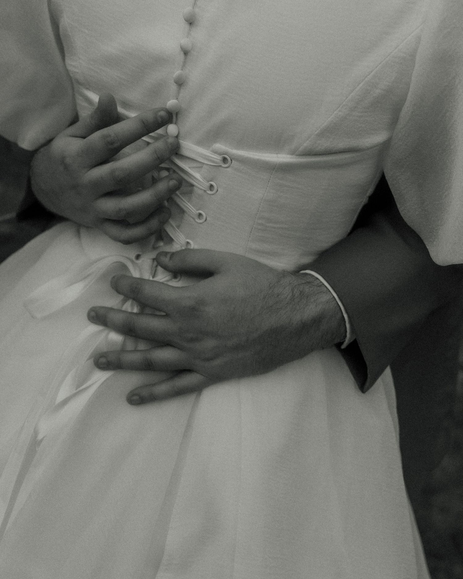 Black and white photo sequence showing hands placing a wedding ring on a finger during a marriage ceremony.