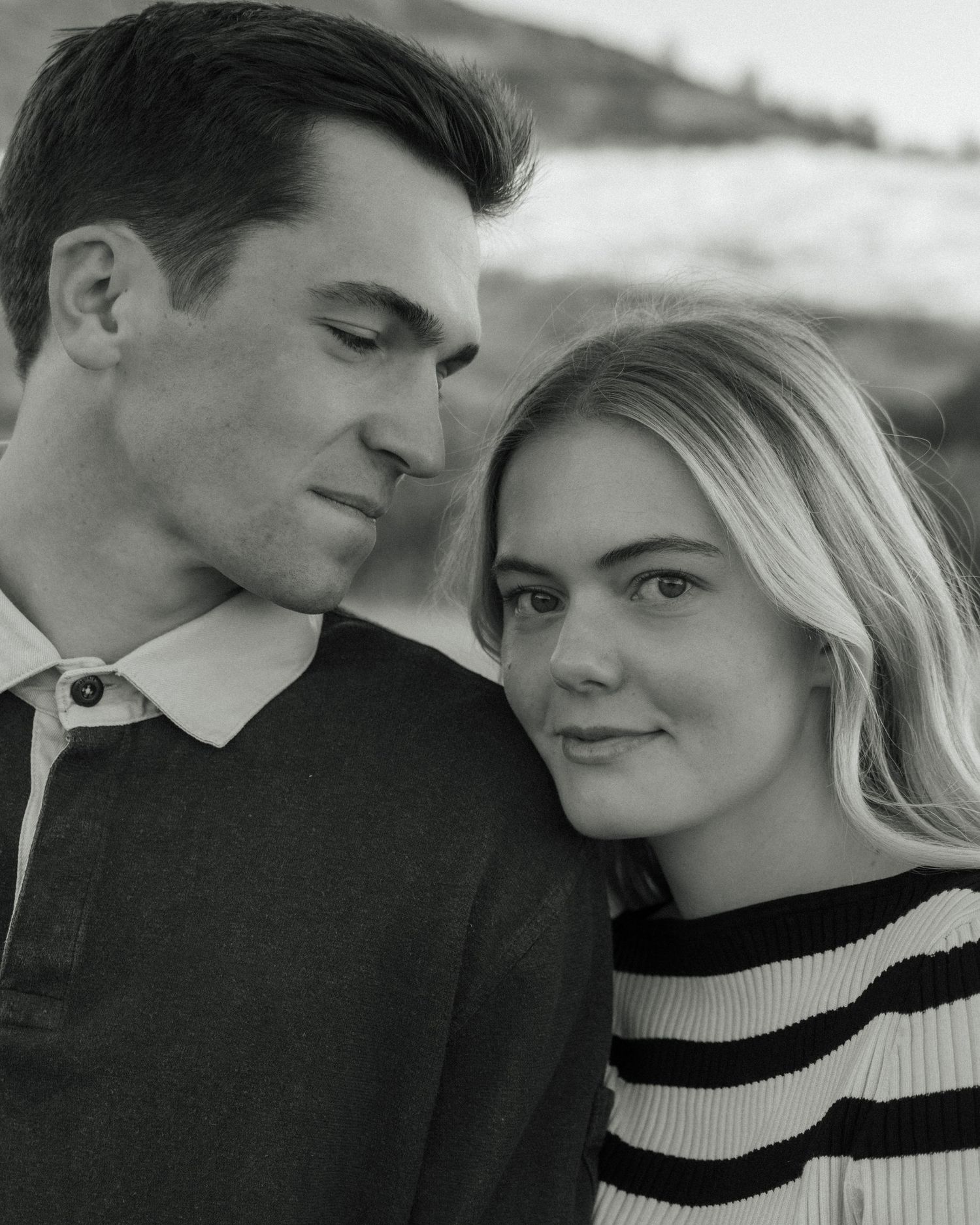 A romantic black and white photo series showing a couple in intimate poses wearing black and white sweaters.