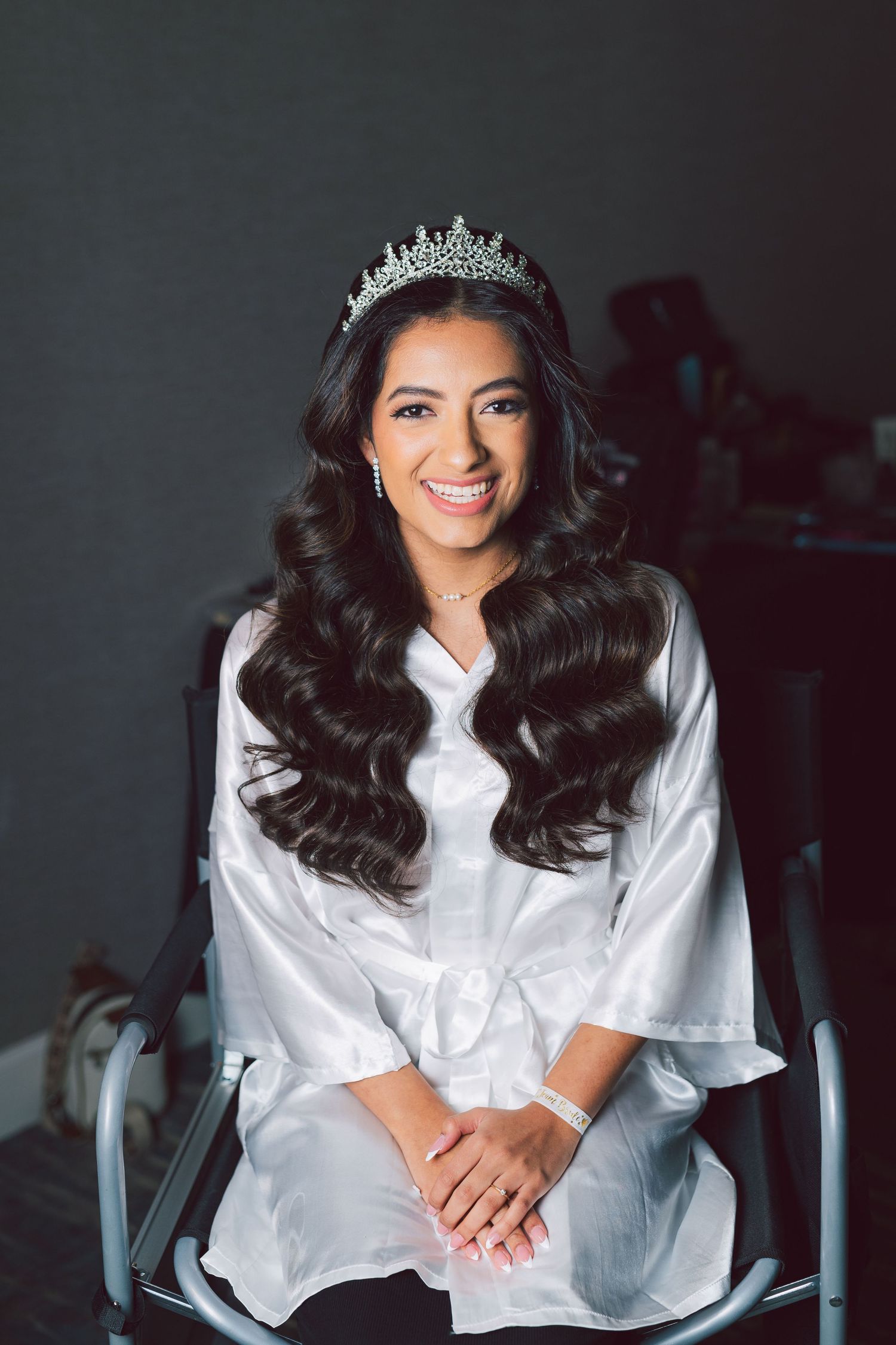 A white silk robe and tiara create an elegant pre-wedding preparation scene.