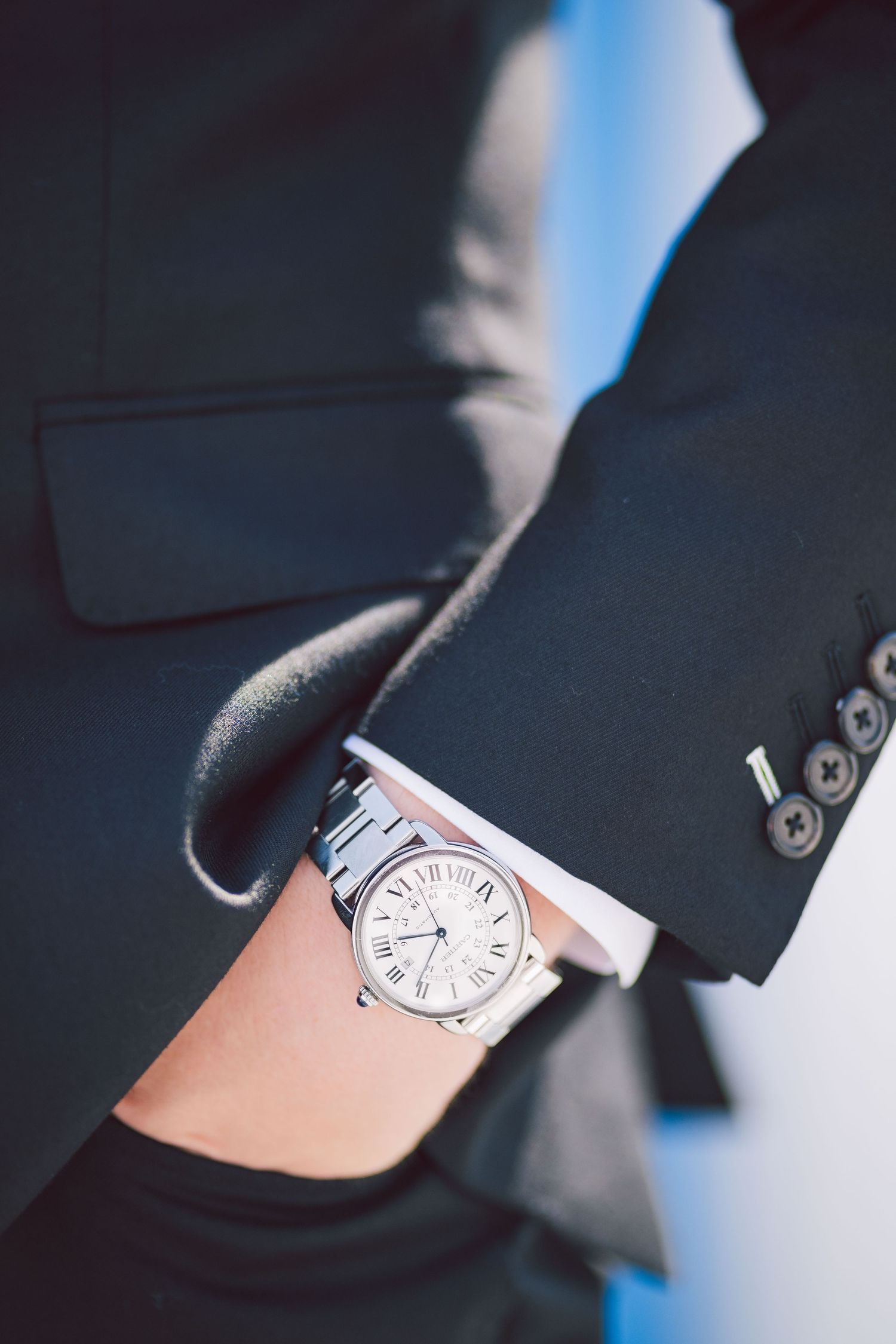 Close-up shots of an elegant watch on a wrist against a dark background.