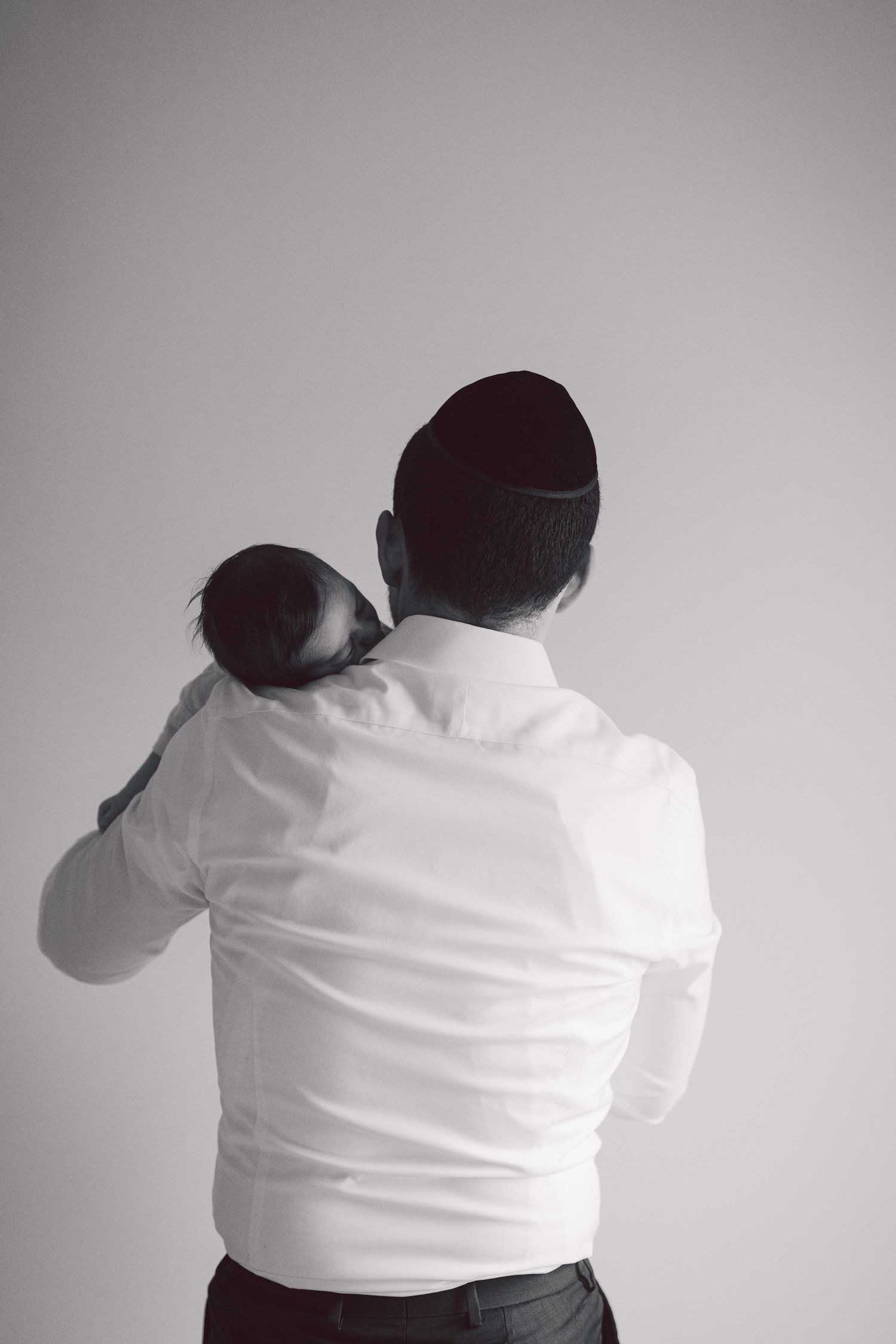 Series of minimalist photos showing someone in a white shirt against a gray background.