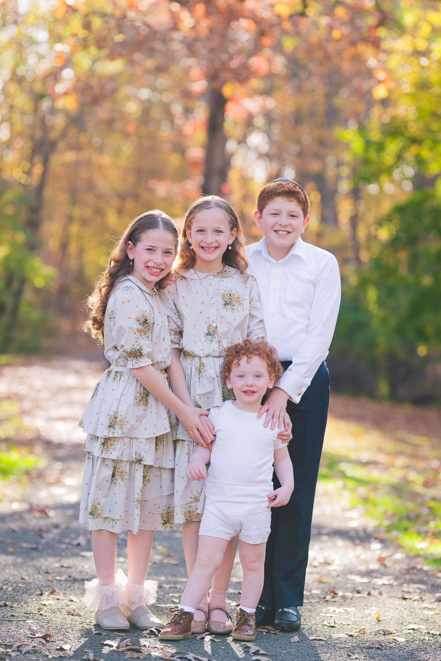 Group of children in matching outfits posing together during autumn season.
