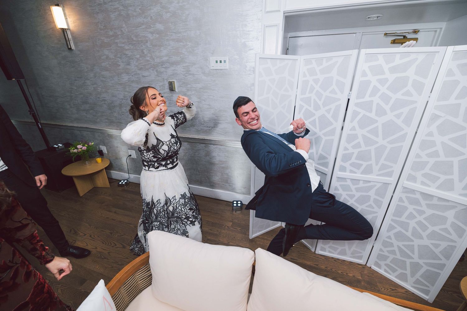 Modern indoor photoshoot setup with studio lights and decorative screens.