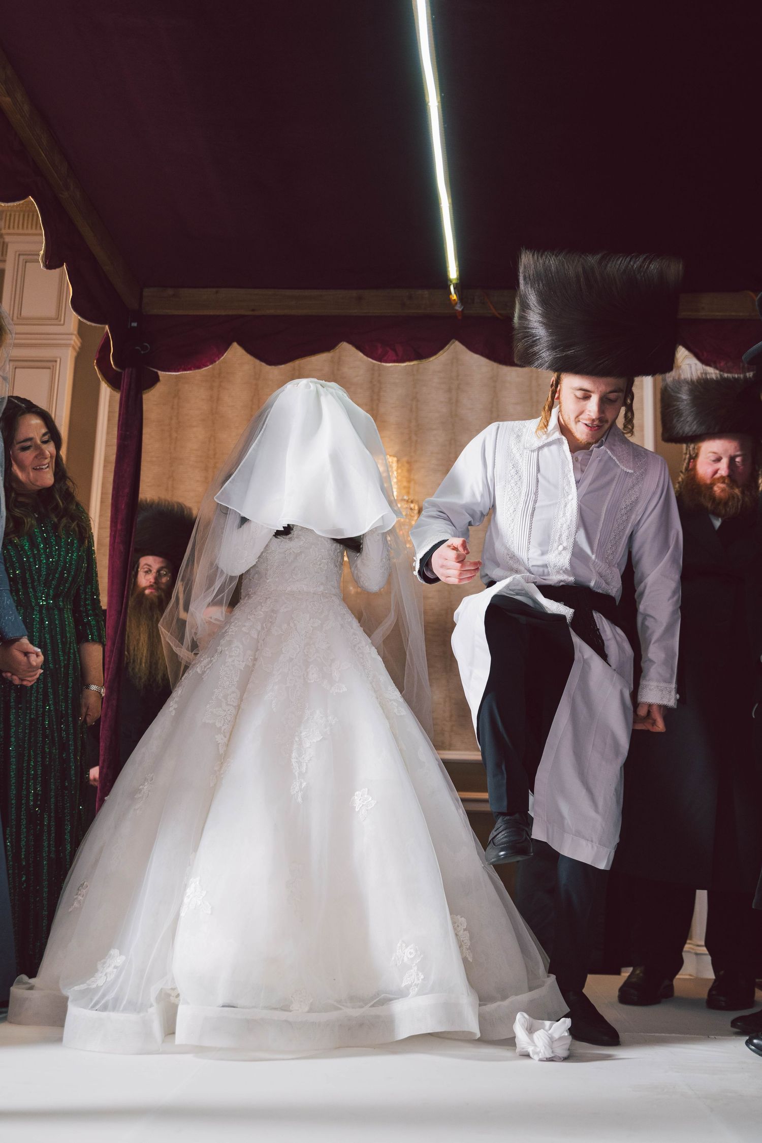 Traditional wedding dance circle with white dress in center.