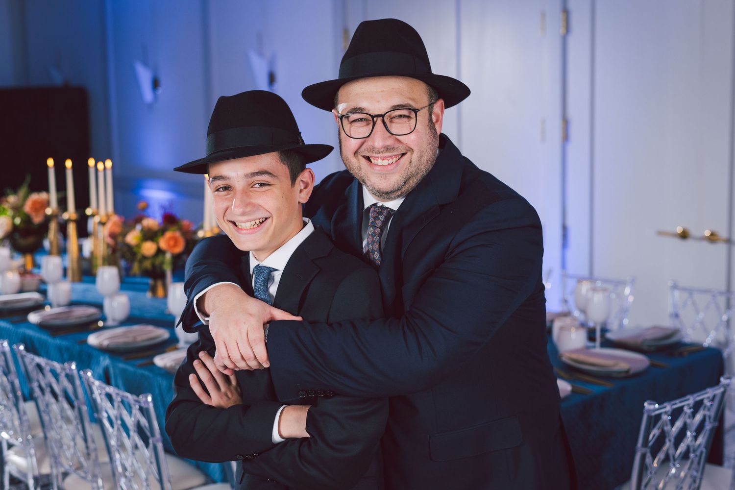 Formal event photography in modern venue with blue ambient lighting.