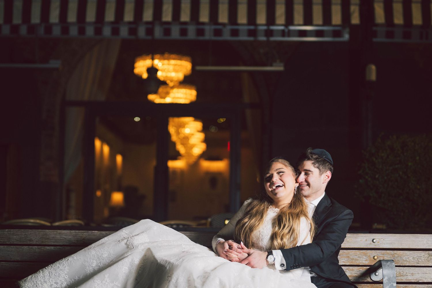 Romantic dance floor moment between newlyweds under warm lighting at reception.