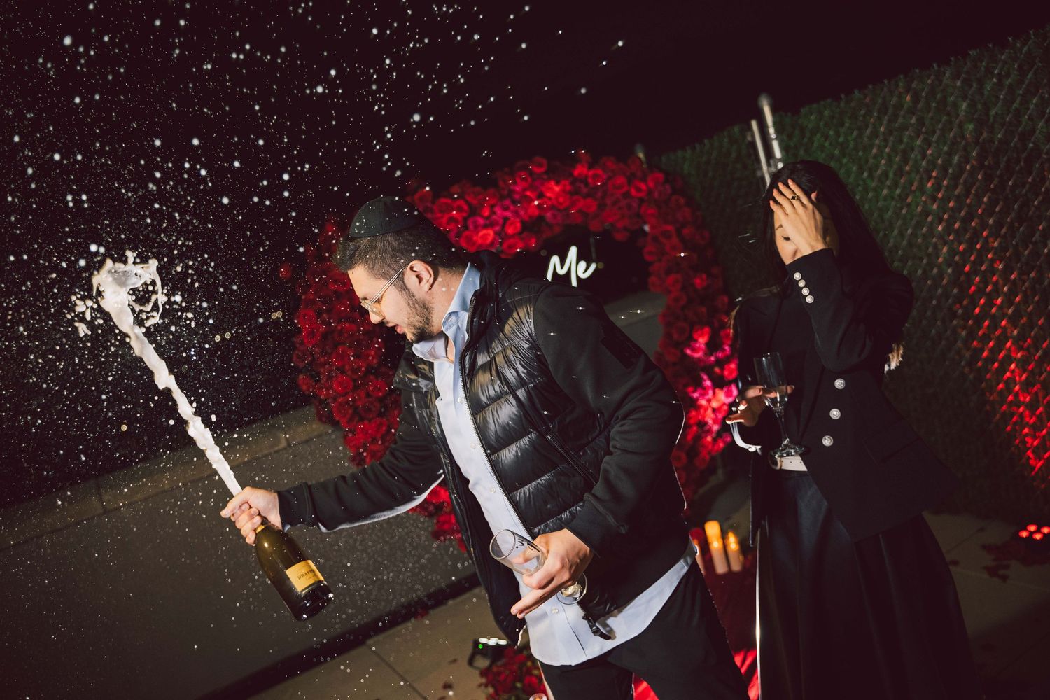 Candlelit proposal scene with dramatic red rose heart display and glowing lanterns.