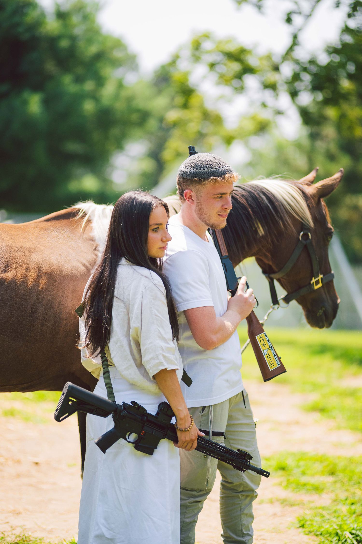 Sweet countryside engagement photos with a friendly brown horse in a sunny field.