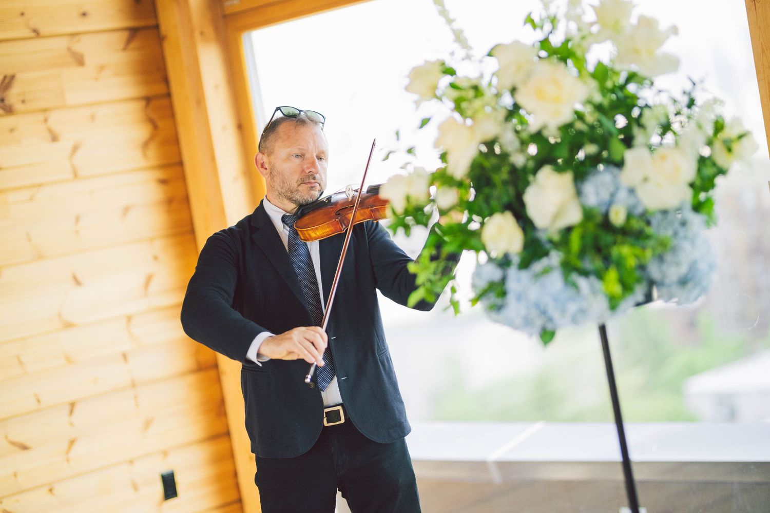 Elegant indoor venue with wooden walls and floral decorations.