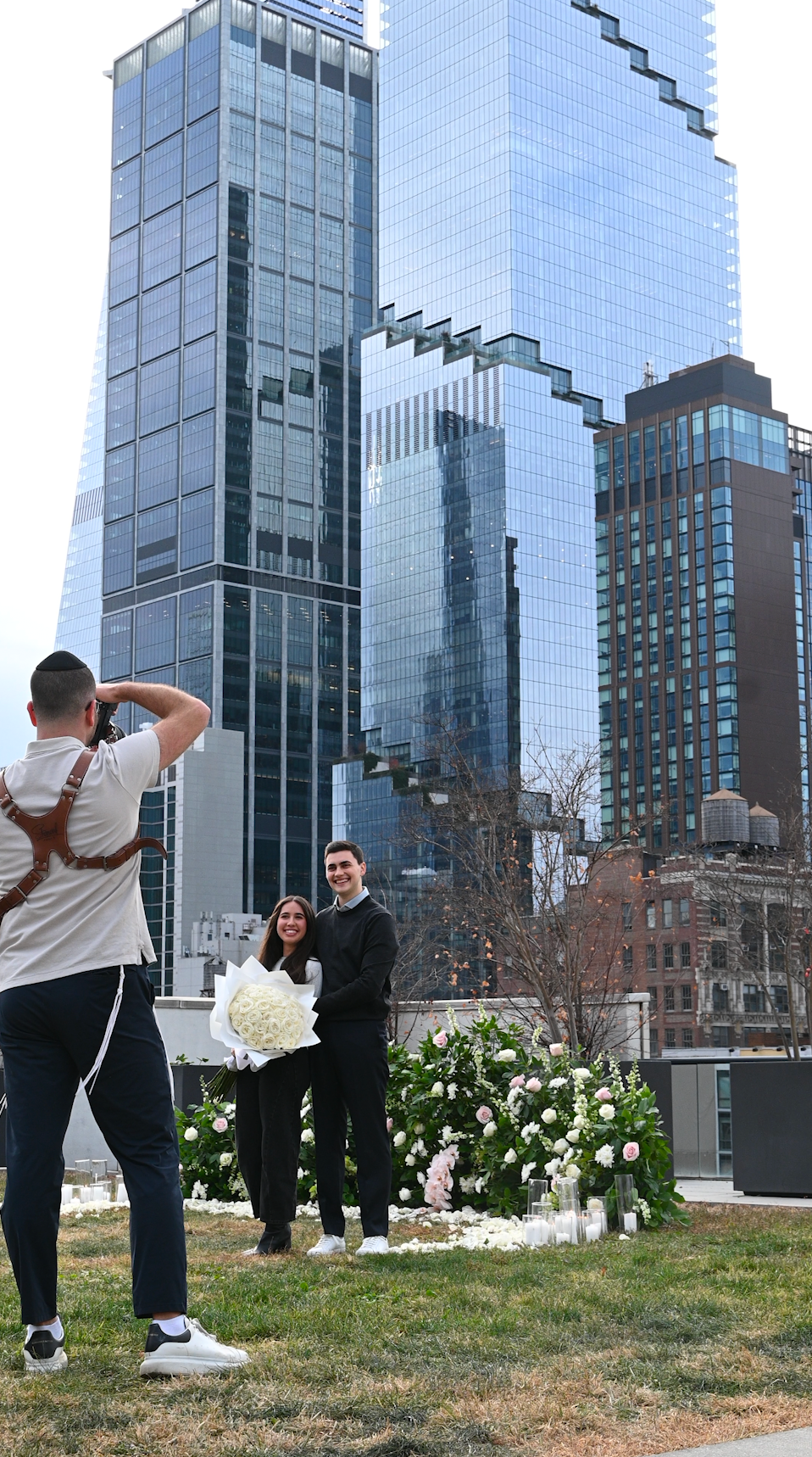 Modern glass buildings serve as backdrop for outdoor wedding photography.