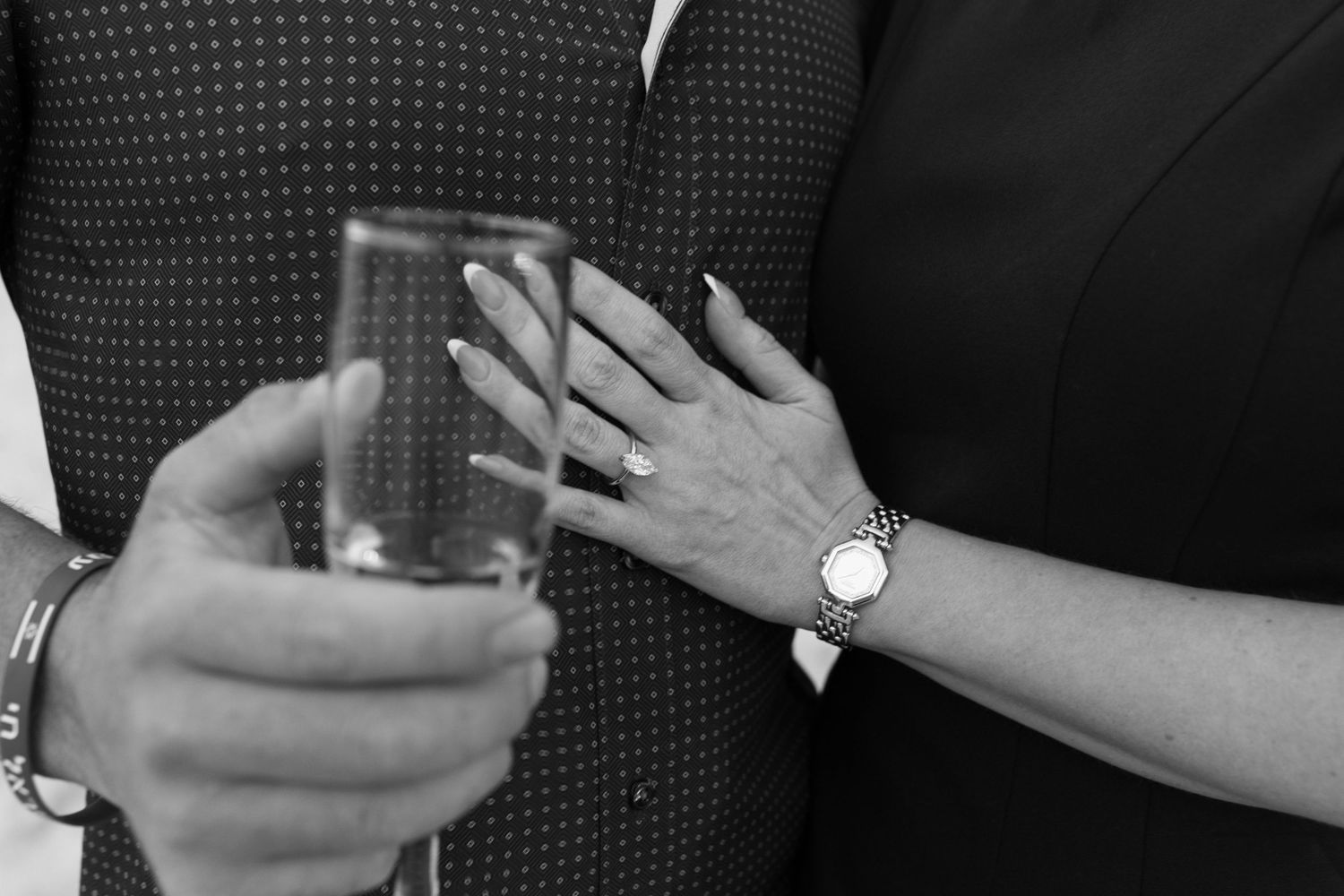 Close-up details of engagement ring and hands during special moment.