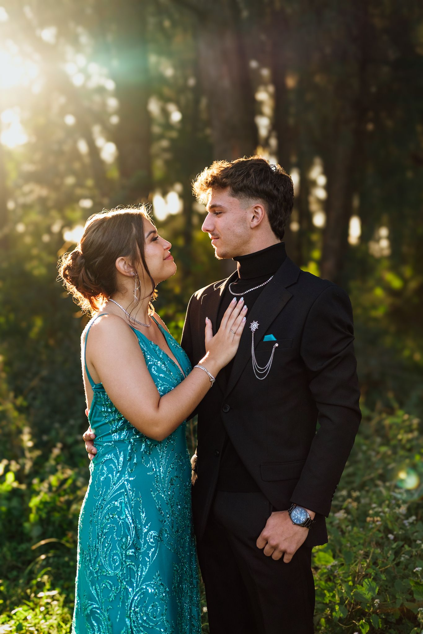 Matric farewell couple looking at each other in a forest setting
