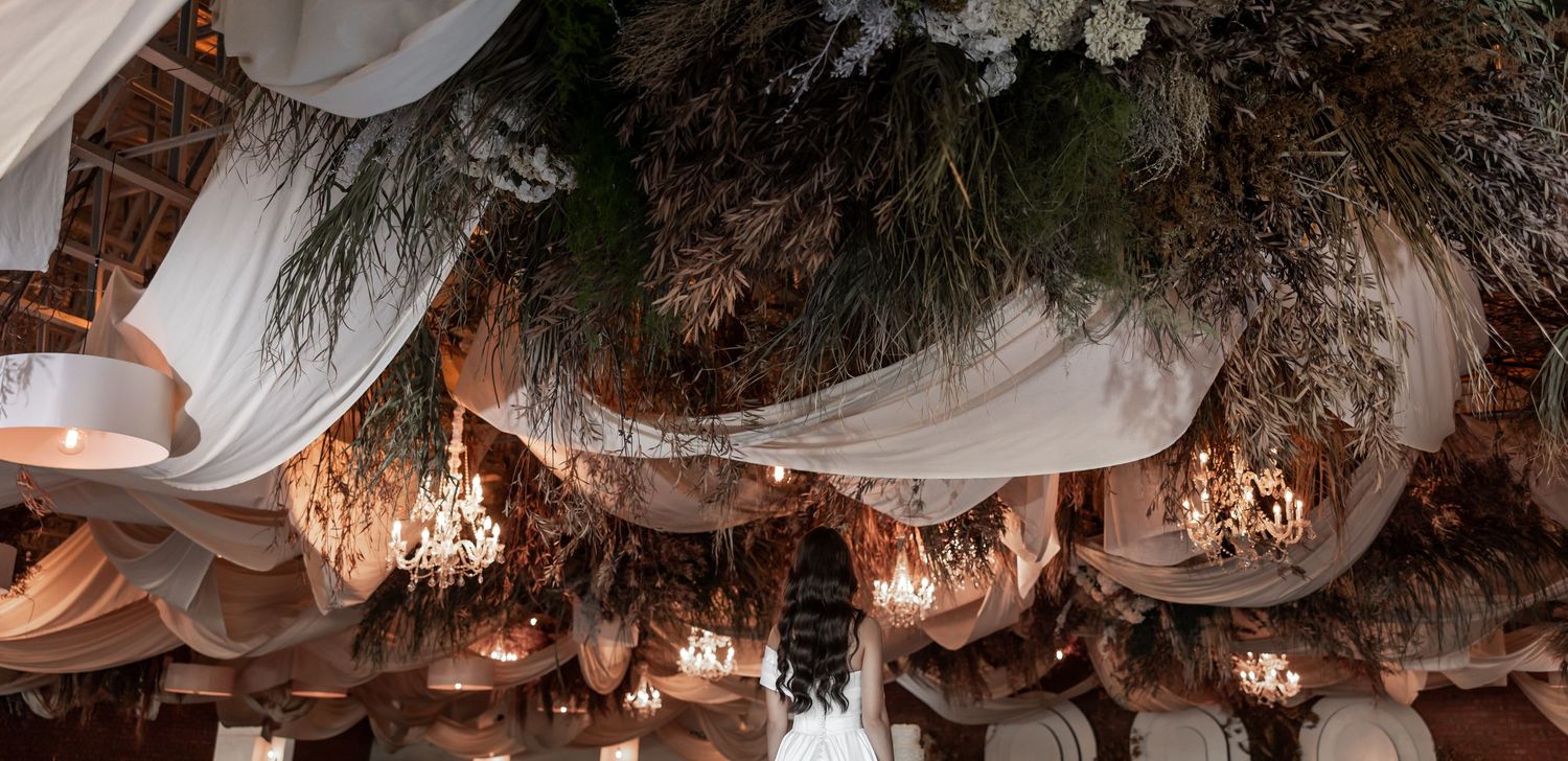 Wedding reception decor with hanging floral arrangements and draped fabric. - JCclick Wedding photo & Film - Best Cape Town Photographer.