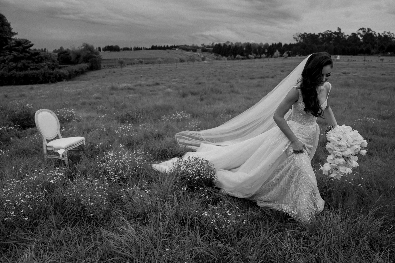Black and white wedding photography showing flowing dress movements in a natural field setting. - JCclick Wedding photo & Film - Best Cape T