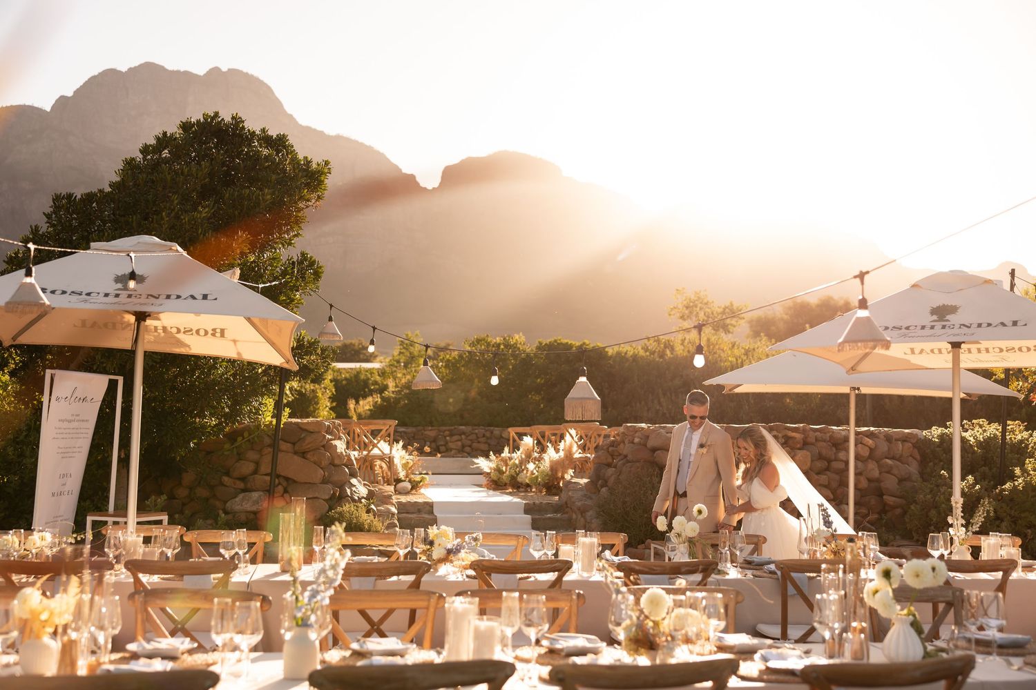 Sunset view of an elegant outdoor wedding reception setup with white decor. - JCclick Wedding photo & Film - Best Cape Town Photographer.