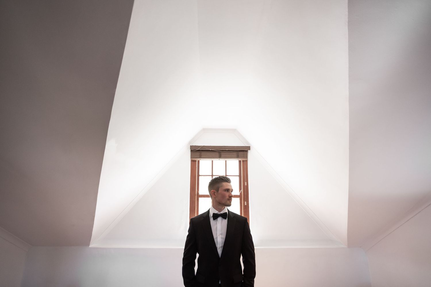 Minimalist white interior with dramatic lighting and architectural elements. - JCclick Wedding photo & Film - Best Cape Town Photographer.