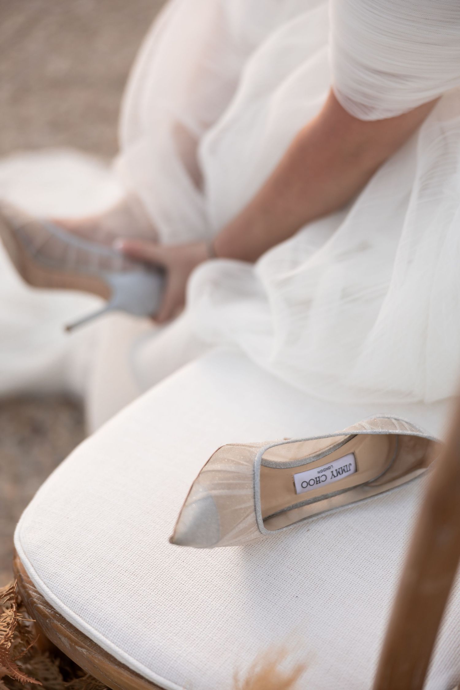Close-up of elegant bridal shoe detail on white fabric with soft focus. - JCclick Wedding photo & Film - Best Cape Town Photographer.