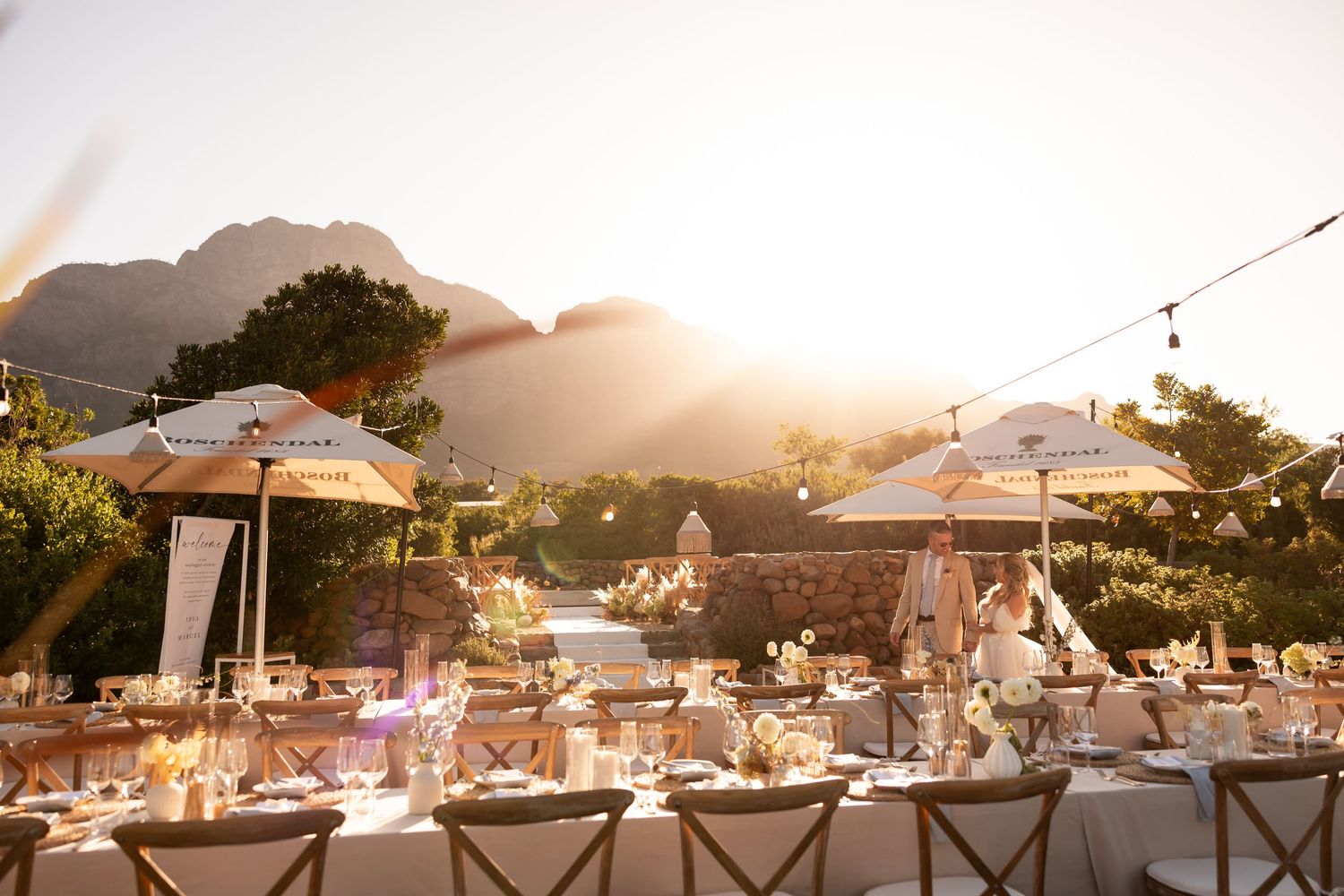 Outdoor wedding reception in cape town setup with mountain views at sunset. - JCclick Wedding photo & Film - Best Cape Town Photographer.
