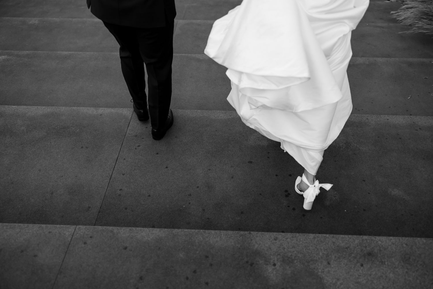 Black and white photograph of flowing wedding dress fabric against concrete floor. - JCclick Wedding photo & Film - Best Cape Town Photograp