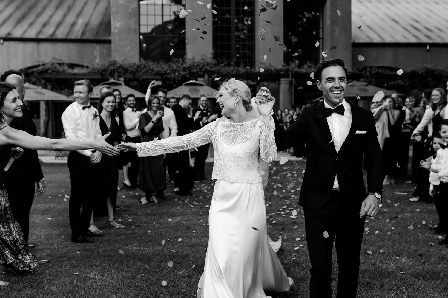 Wedding celebration with guests throwing confetti during outdoor festivities. - JCclick Wedding photo & Film - Best Cape Town Photographer.