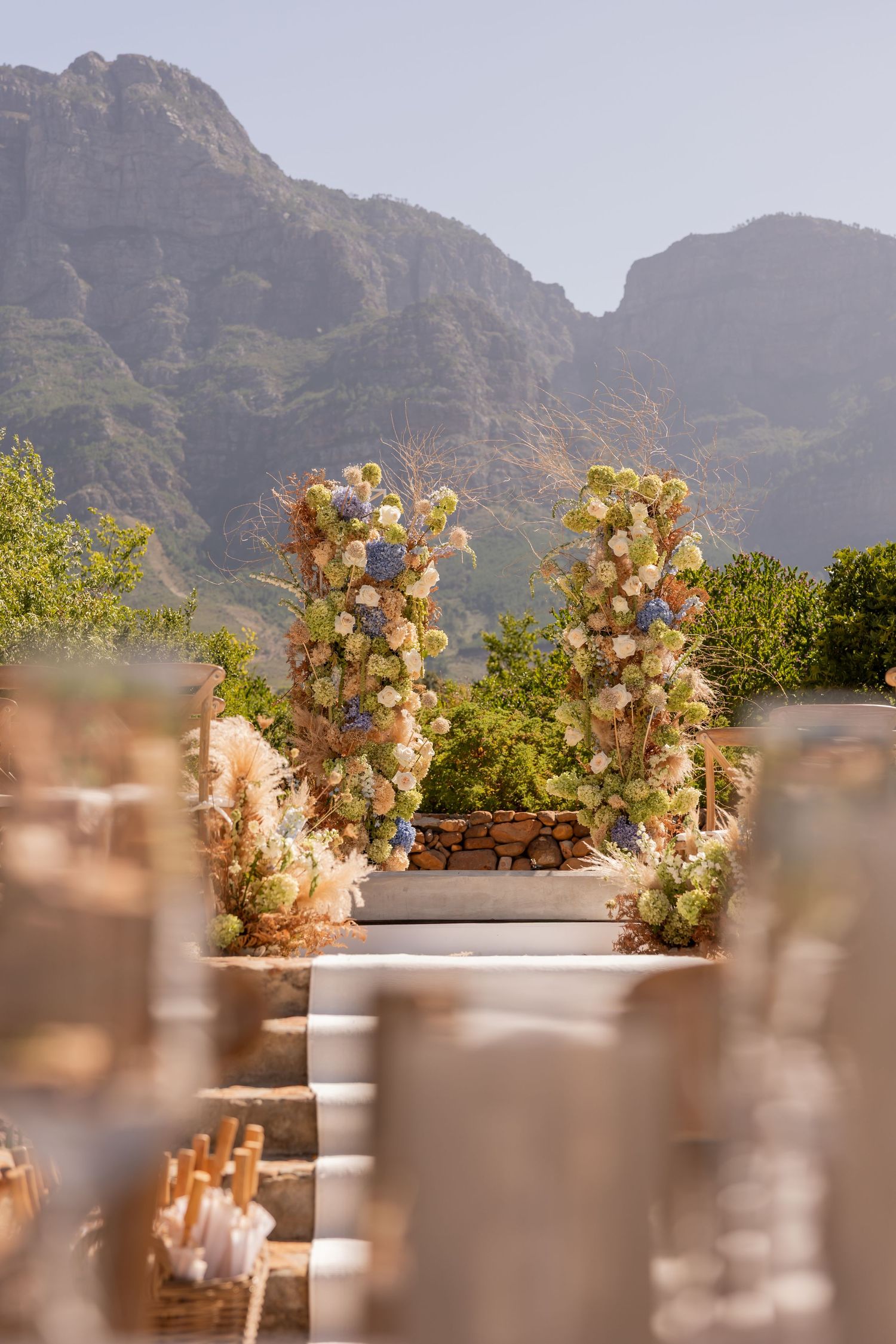 Floral arrangements and table settings with mountain backdrop in Cape Town. - JCclick Wedding photo & Film - Best Cape Town Photographer.