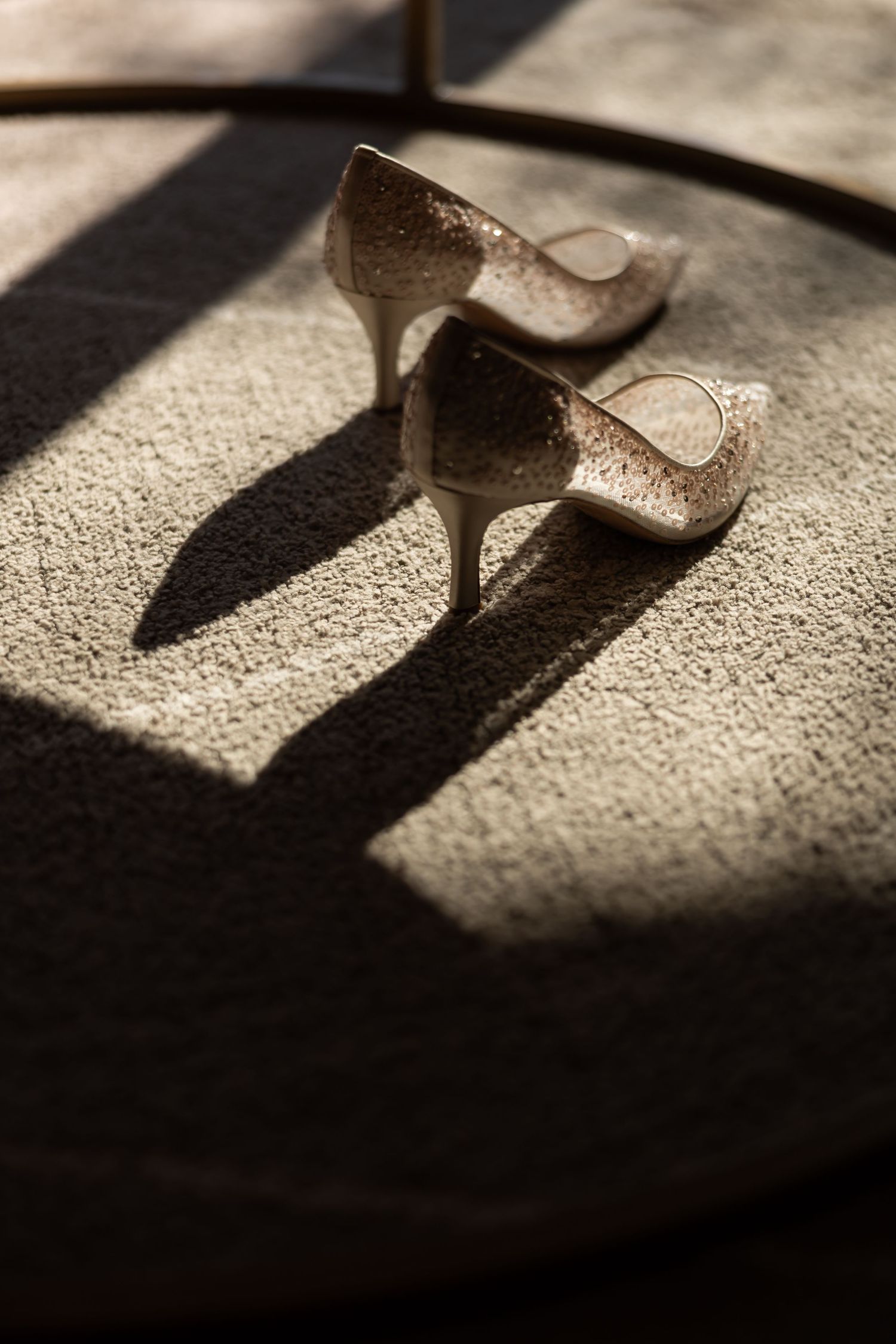 Shadow of elegant high heels cast on textured ground in dramatic lighting.  JCclick Wedding photo & Film - Best Cape Town Photographer.