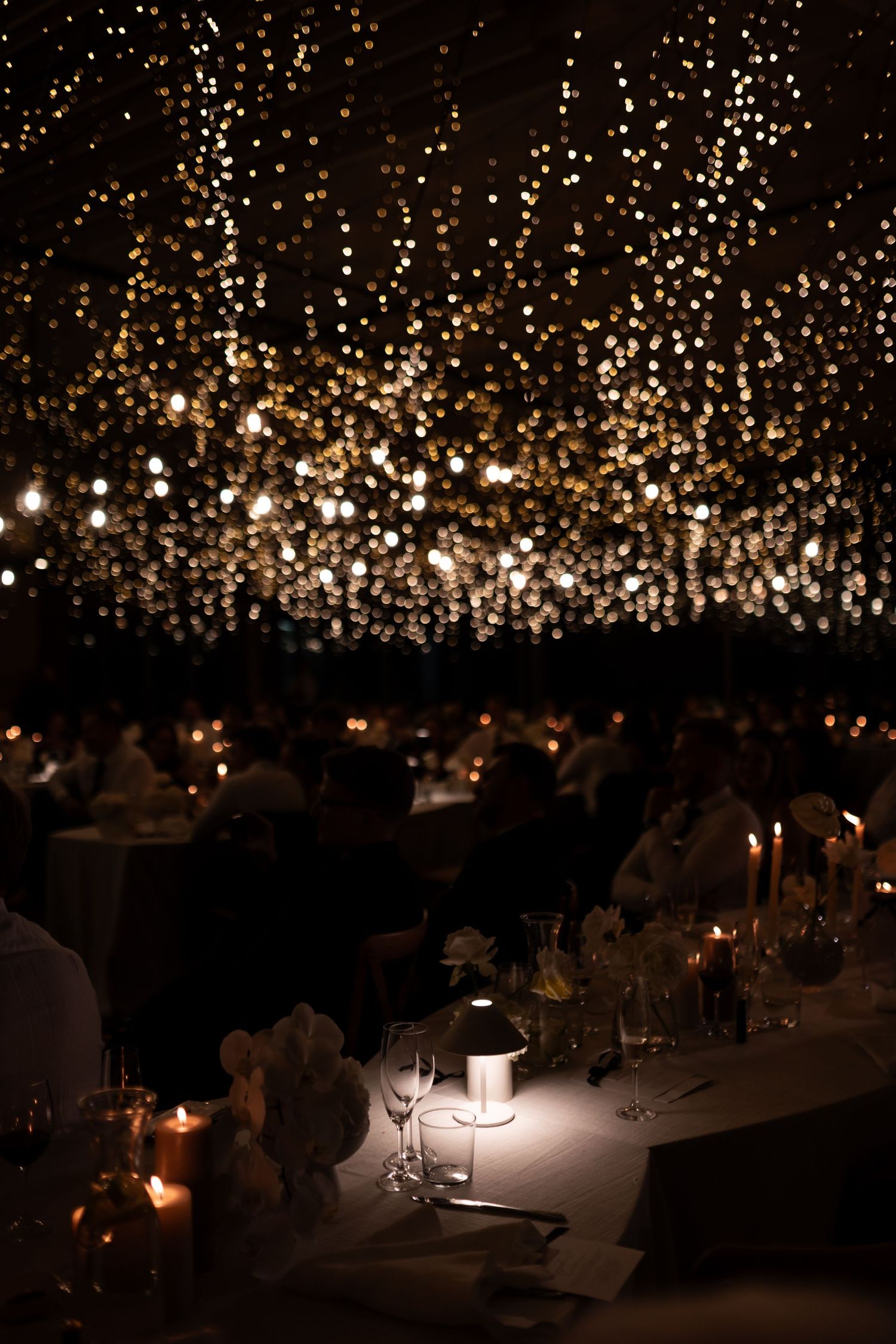 Elegant wedding reception venue with twinkling lights creating a magical starlit ceiling effect. - JCclick Wedding photo & Film - Best Cape