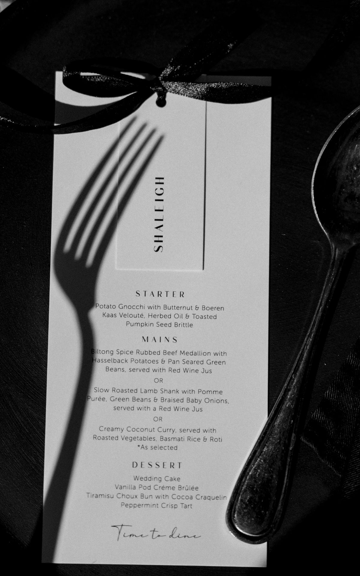 Wedding menu card with fork shadow cast across elegant typography. - JCclick Wedding photo & Film - Best Cape Town Photographer.