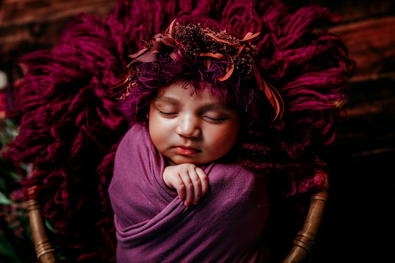 A series of artistic portrait photographs with deep burgundy tones and dramatic lighting effects.