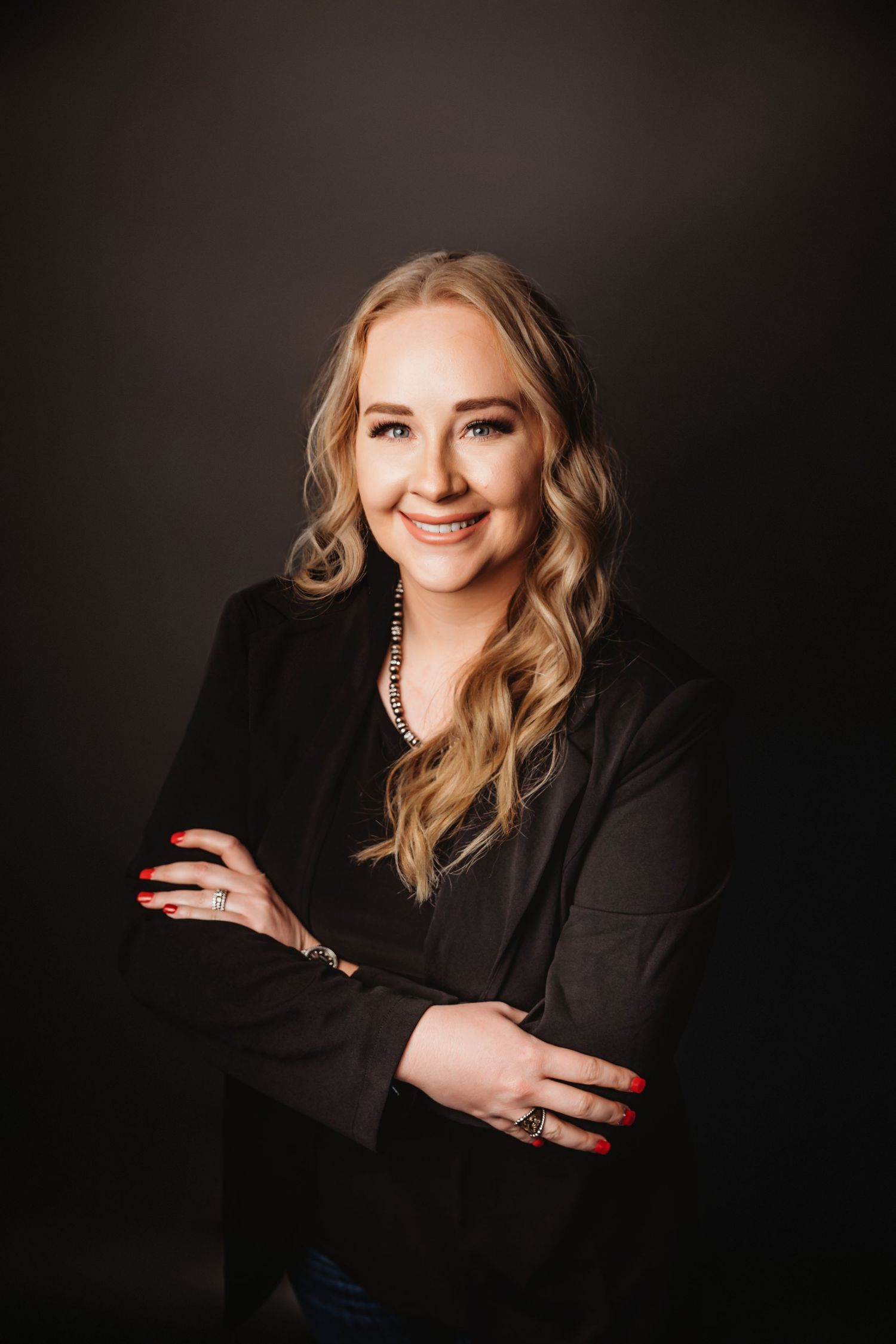 Professional studio portraits with dramatic lighting against a dark backdrop.