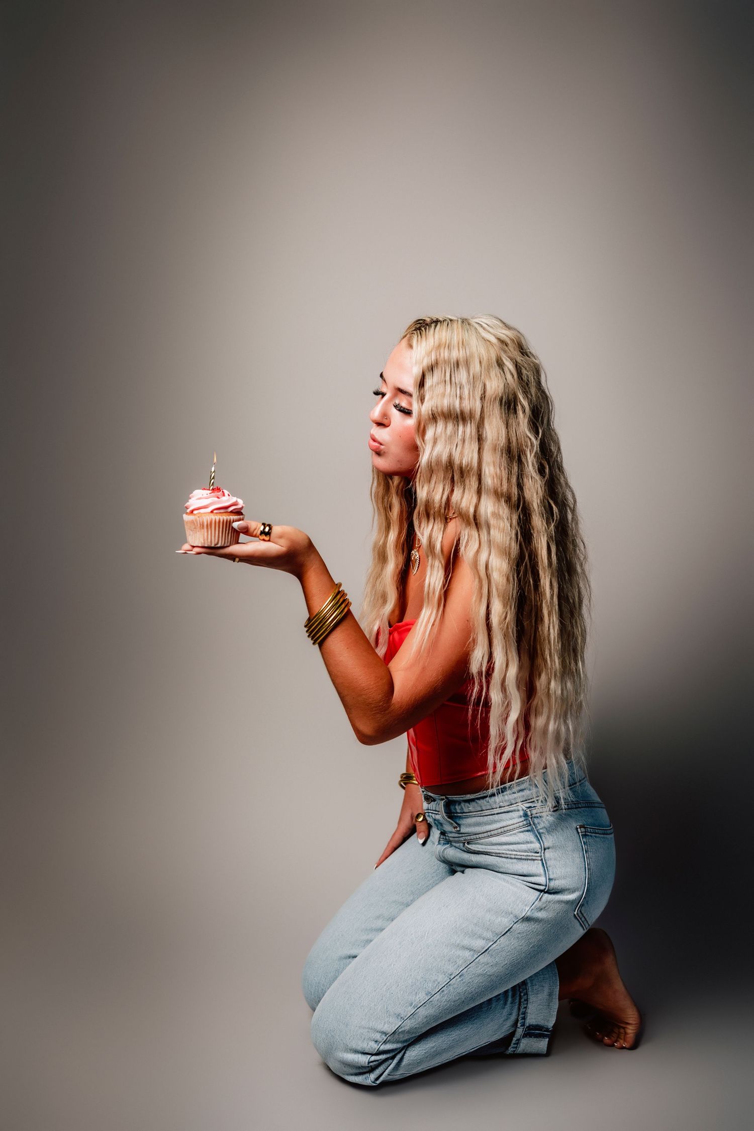 Artistic portrait series of woman with long hair posing with smoke in studio setting.