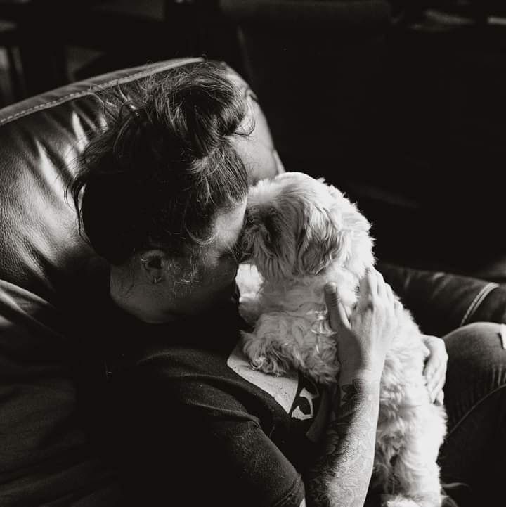Black and white photo series showing a tender moment between a human and their pet in one last embrace.