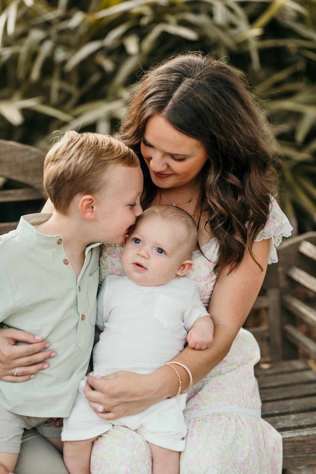 An intimate family portrait shows tender moments between parents and children.