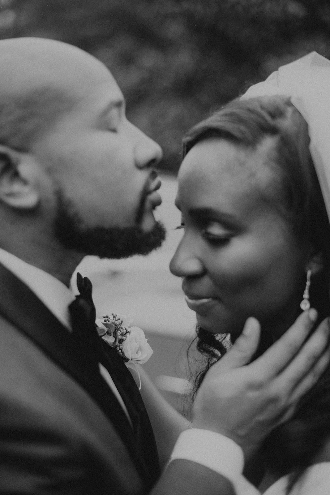 A romantic black and white wedding photo series showing intimate moments between a couple in formal attire.