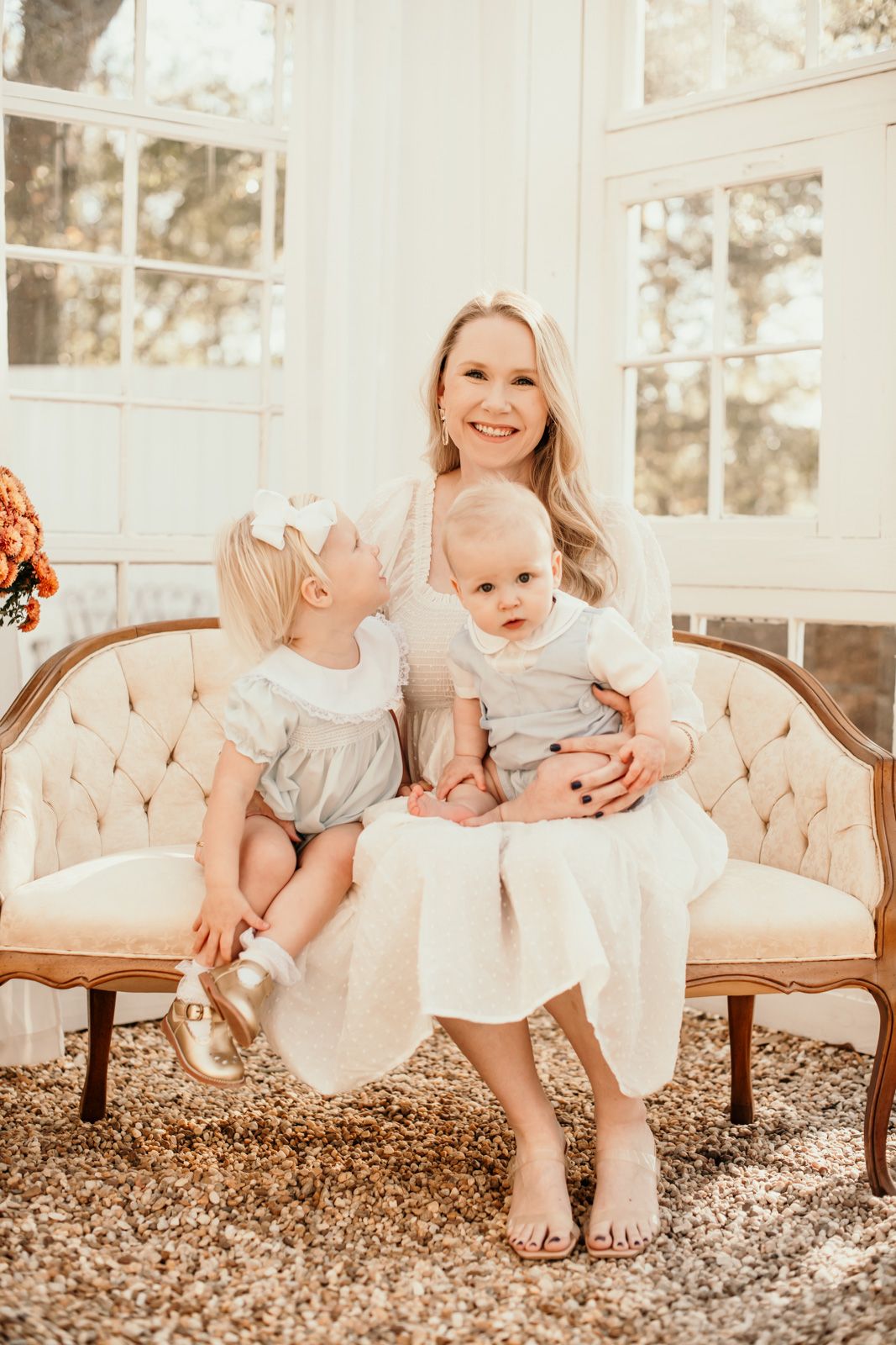 A series of three photos showing tender family moments on a beige tufted settee in a bright, sunlit room.